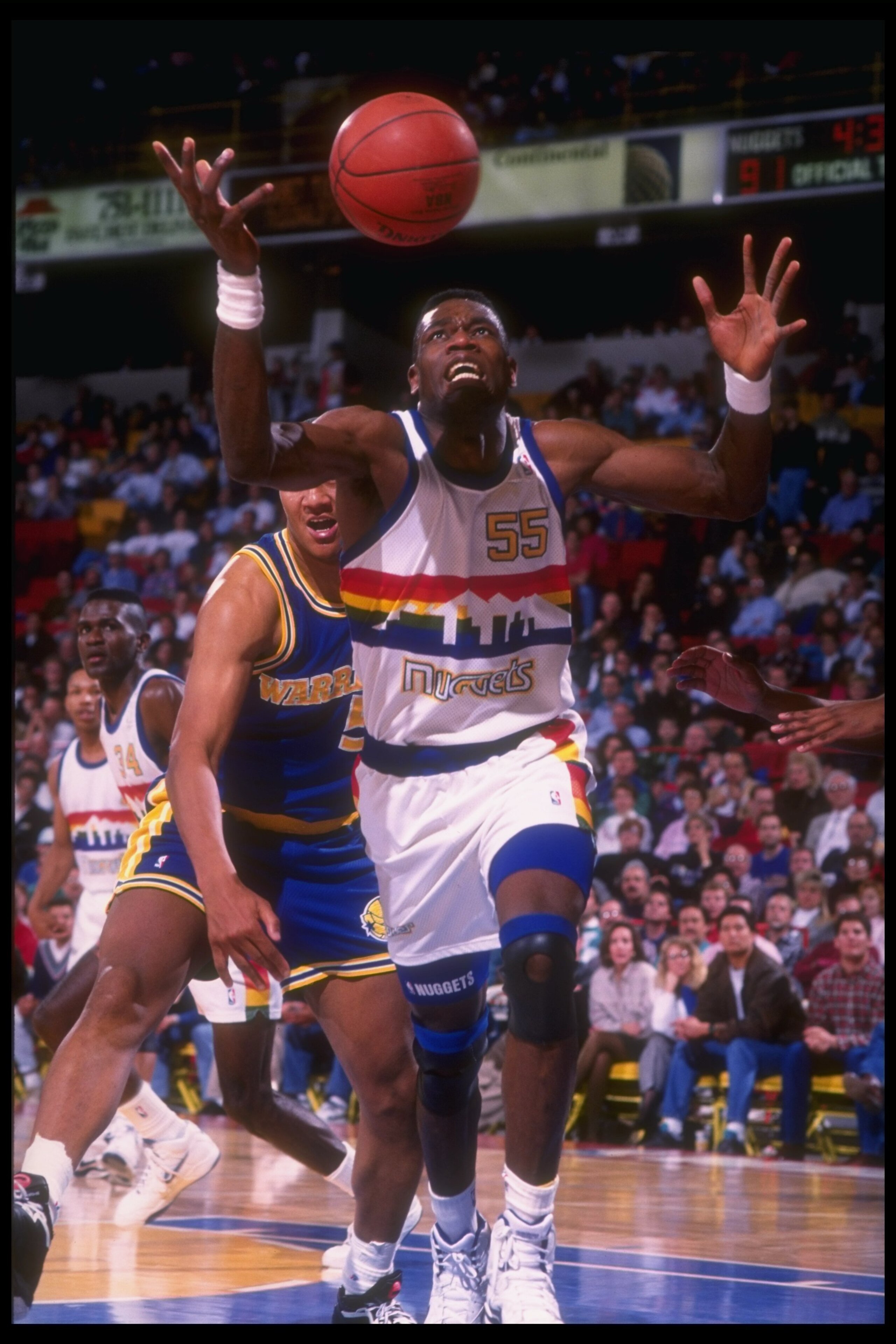 1991-1992: Center Dikembe Mutombo of the Denver Nuggets goes after a loose ball during a game versus the Golden State Warriors at the McNichols Sports Arena in Denver, Colorado. Mandatory Credit: Tim DeFrisco /Allsport Mandatory Credit: Tim DeFrisco /A 1991-1992: Center Dikembe Mutombo of the Denver Nuggets goes after a loose ball during a game versus the Golden State Warriors at the McNichols Sports Arena in Denver, Colorado. Mandatory Credit: Tim DeFrisco /Allsport Mandatory Credit: Tim DeFrisco /A
