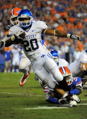 GAINESVILLE, FL - SEPTEMBER 25:  Running back Derrick Locke #20 of the Kentucky Wildcats is brought down by safety Ahmad Black #35 of the Florida Gators at Ben Hill Griffin Stadium on September 25, 2010 in Gainesville, Florida.  (Photo by Doug Benc/Getty