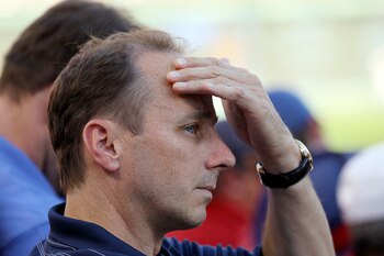 ARLINGTON, TX - OCTOBER 16:  General Manager of the New York Yankees Brian Cashman look on during a game against the Texas Rangers in Game Two of the ALCS during the 2010 MLB Playoffs at Rangers Ballpark in Arlington on October 16, 2010 in Arlington, Texa