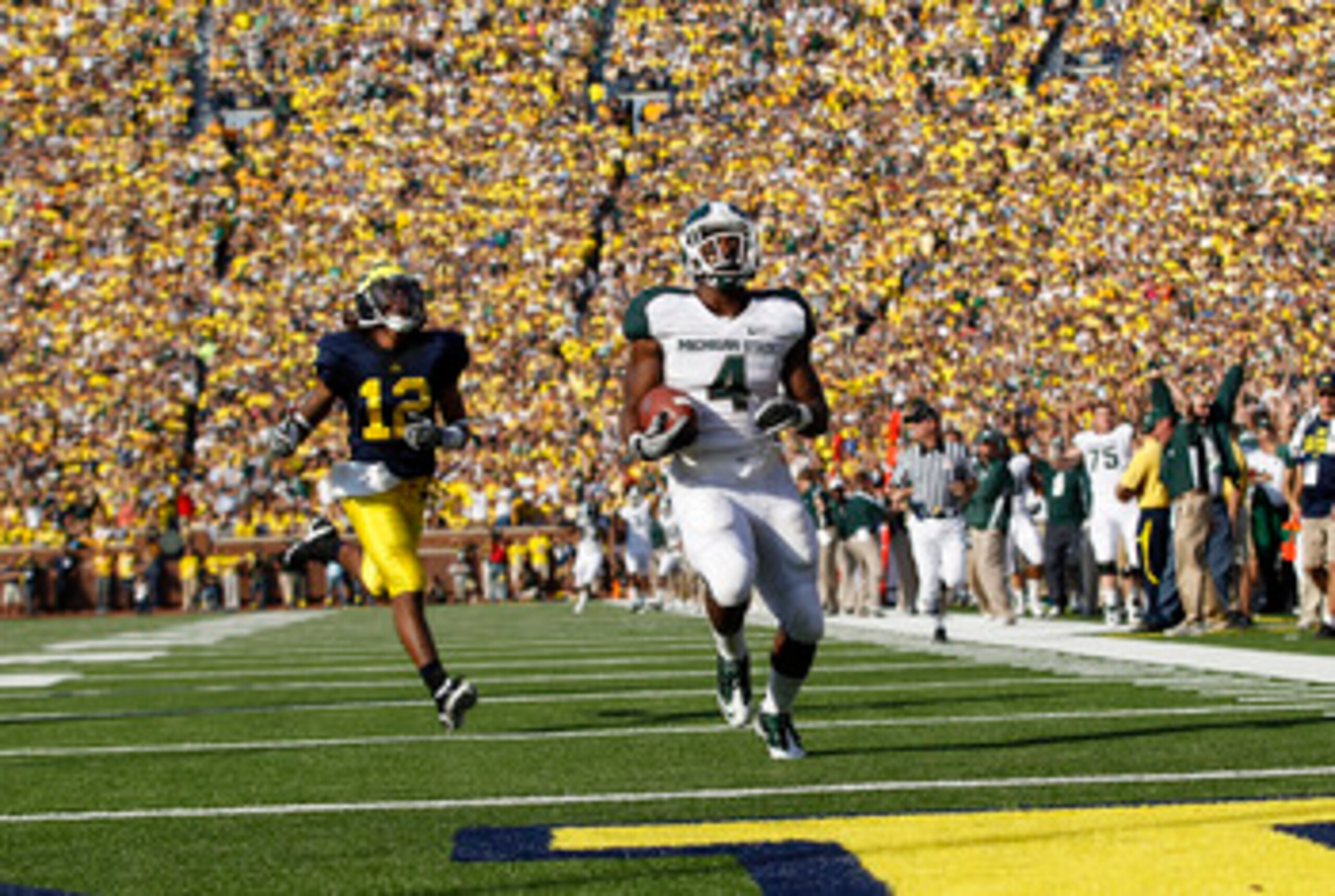 ANN ARBOR, MI - OCTOBER 09: Edwin Baker #4 of the Michigan State Spartans scores on a 61 yard touchdown in the second quarter against the Michigan Wolverines during the game on October 9, 2010 at Michigan Stadium in Ann Arbor, Michigan. The Michigan Stat ANN ARBOR, MI - OCTOBER 09: Edwin Baker #4 of the Michigan State Spartans scores on a 61 yard touchdown in the second quarter against the Michigan Wolverines during the game on October 9, 2010 at Michigan Stadium in Ann Arbor, Michigan. The Michigan Stat