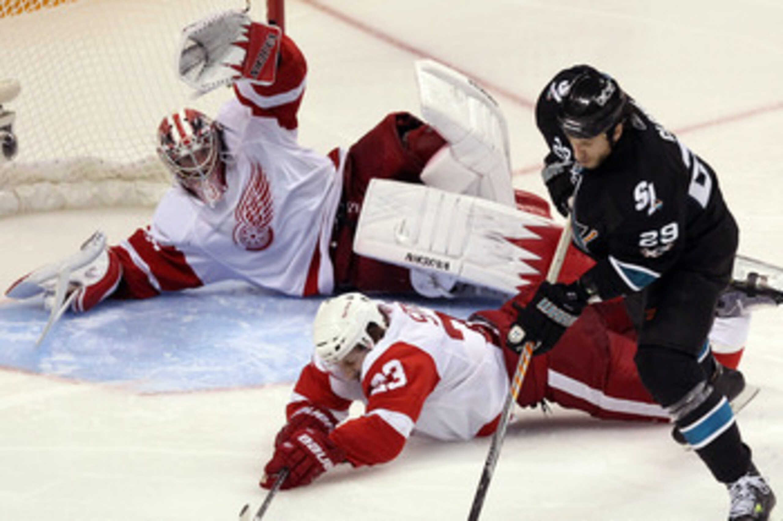 SAN JOSE, CA - APRIL 29: Brad Stuart #23 and Jimmy Howard #35 of the Detroit Red Wings dive to stop a shot by Ryane Clowe #29 of the San Jose Sharks in Game One of the Western Conference Semifinals during the 2011 NHL Stanley Cup Playoffs at HP Pavilion SAN JOSE, CA - APRIL 29: Brad Stuart #23 and Jimmy Howard #35 of the Detroit Red Wings dive to stop a shot by Ryane Clowe #29 of the San Jose Sharks in Game One of the Western Conference Semifinals during the 2011 NHL Stanley Cup Playoffs at HP Pavilion