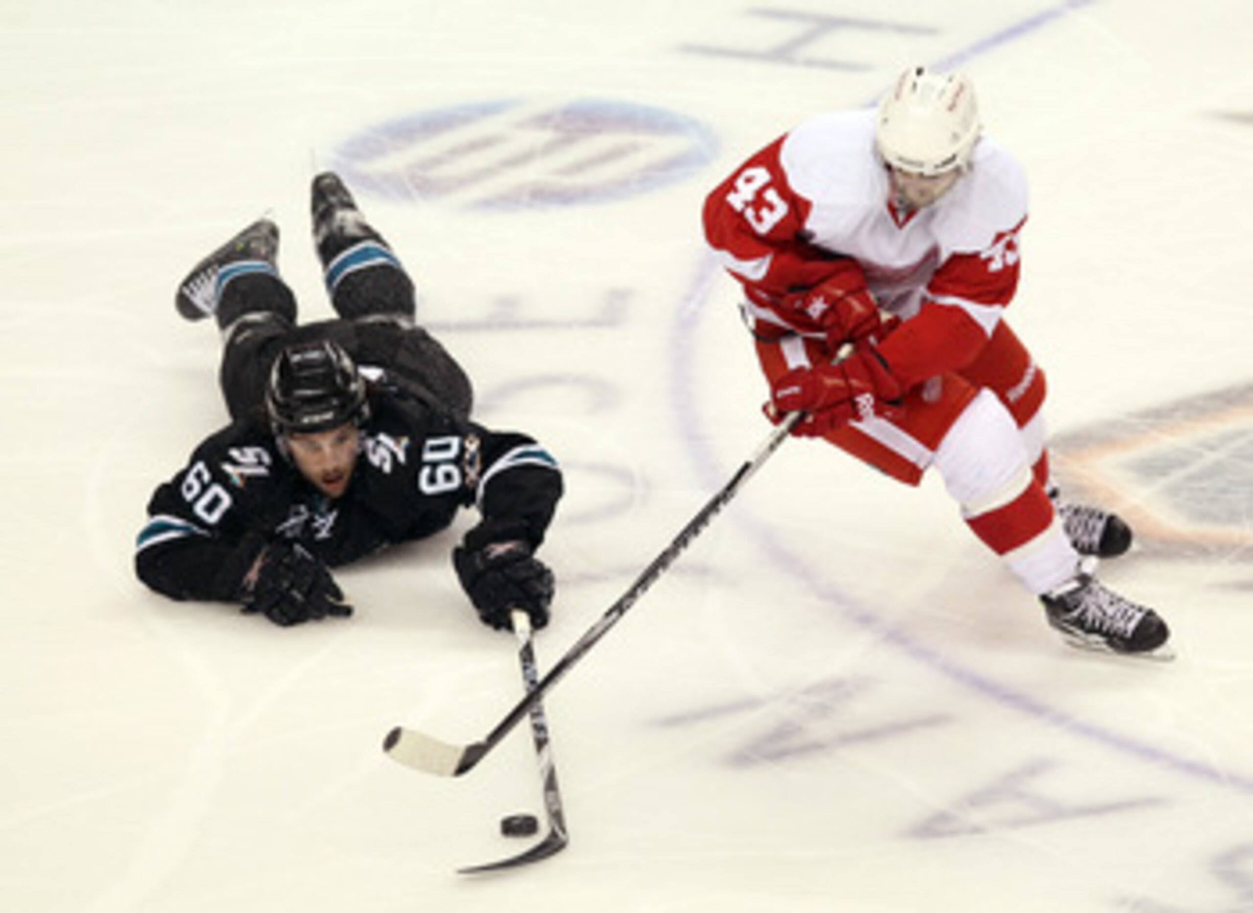 SAN JOSE, CA - APRIL 29: Jason Demers #60 of the San Jose Sharks and Darren Helm #43 of the Detroit Red Wings go for the puck in Game One of the Western Conference Semifinals during the 2011 NHL Stanley Cup Playoffs at HP Pavilion on April 29, 2011 in Sa SAN JOSE, CA - APRIL 29: Jason Demers #60 of the San Jose Sharks and Darren Helm #43 of the Detroit Red Wings go for the puck in Game One of the Western Conference Semifinals during the 2011 NHL Stanley Cup Playoffs at HP Pavilion on April 29, 2011 in Sa