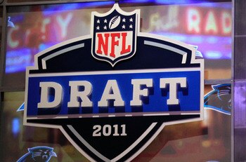NEW YORK, NY - APRIL 28:  Cam Newton, #1 overall pick by the Carolina Panthers holds up a jersey on stage after he was picked during the 2011 NFL Draft at Radio City Music Hall on April 28, 2011 in New York City.  (Photo by Chris Trotman/Getty Images)