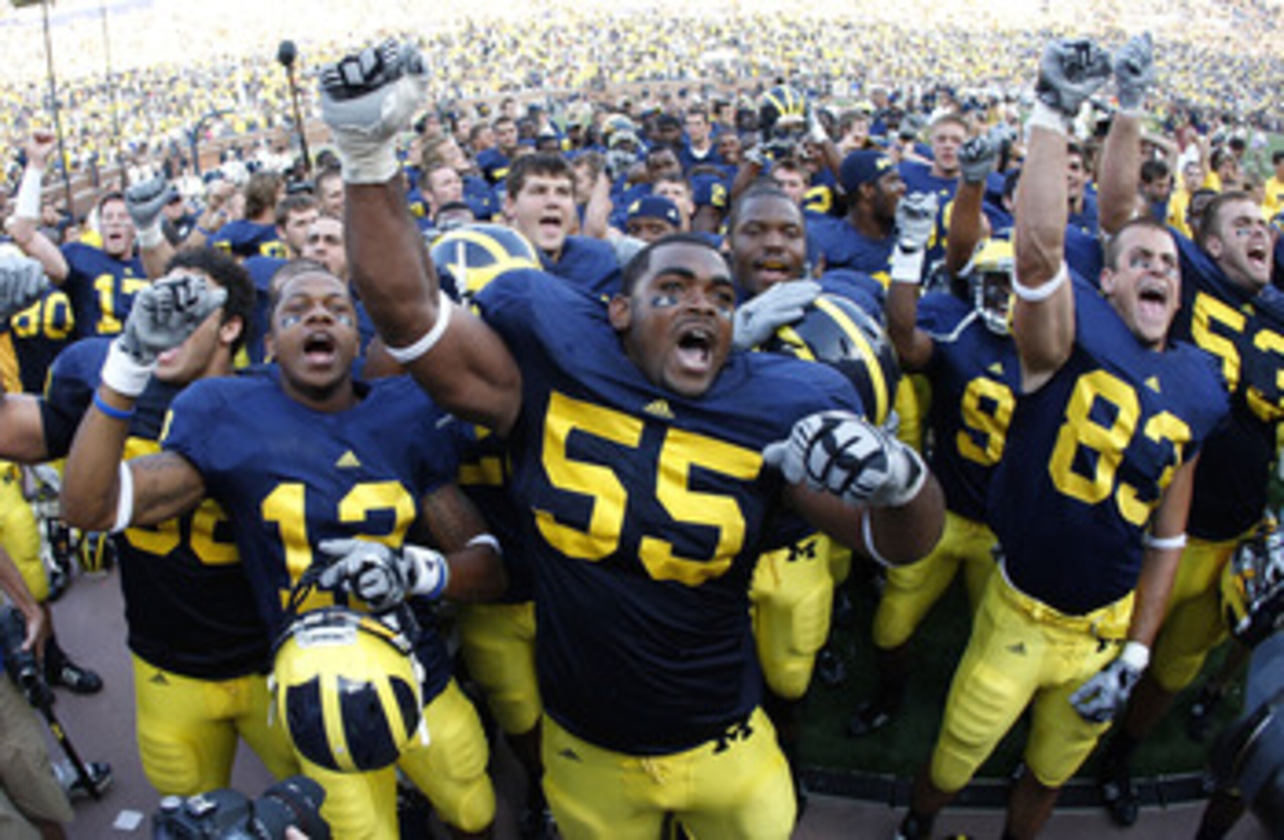 ANN ARBOR, MI - SEPTEMBER 05:  Brandon Graham #55 of the Michigan Wolverines leads his teammates in singing the schools fight song after beating the Western Michigan Broncos 31-7 on September 5, 2009 at Michigan Stadium in Ann Arbor, Michigan.  (Photo by