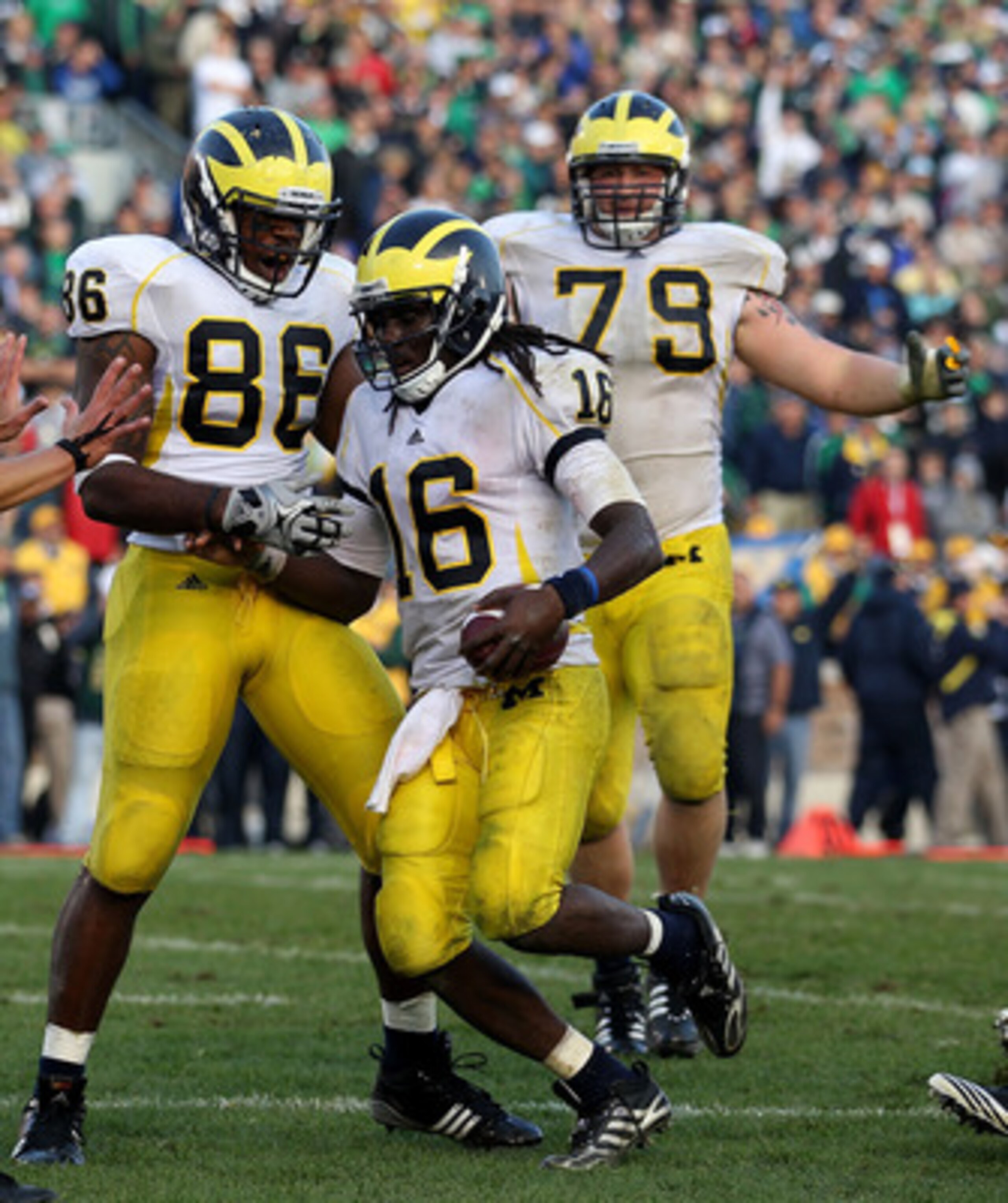 SOUTH BEND, IN - SEPTEMBER 11: Kevin Koger #86 and Perry Dorrestein #79 of the Michigan Wolverines celebrate with Denard Robinson #16 after Robinson scored the game-winning touchdown against against the Notre Dame Fighting Irish at Notre Dame Stadium on S