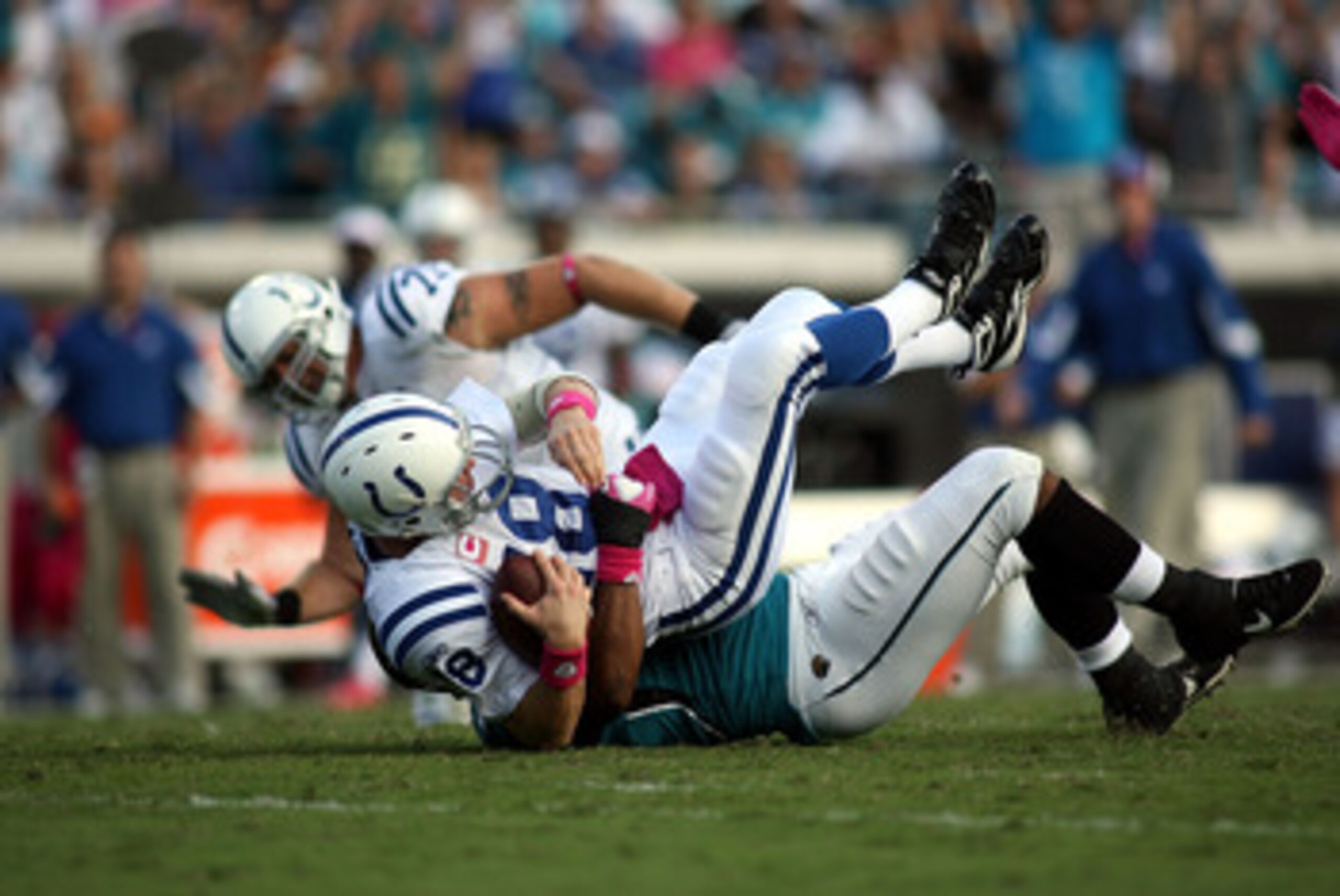 JACKSONVILLE, FL - OCTOBER 03:  Quarterback Peyton Manning #18 of the Indianapolis Colts is sacked by Lineman Jeremy Mincey #94 of the Jacksonville Jaguars at EverBank Field on October 3, 2010 in Jacksonville, Florida. The Jaguars won 31-28.  (Photo by Ma