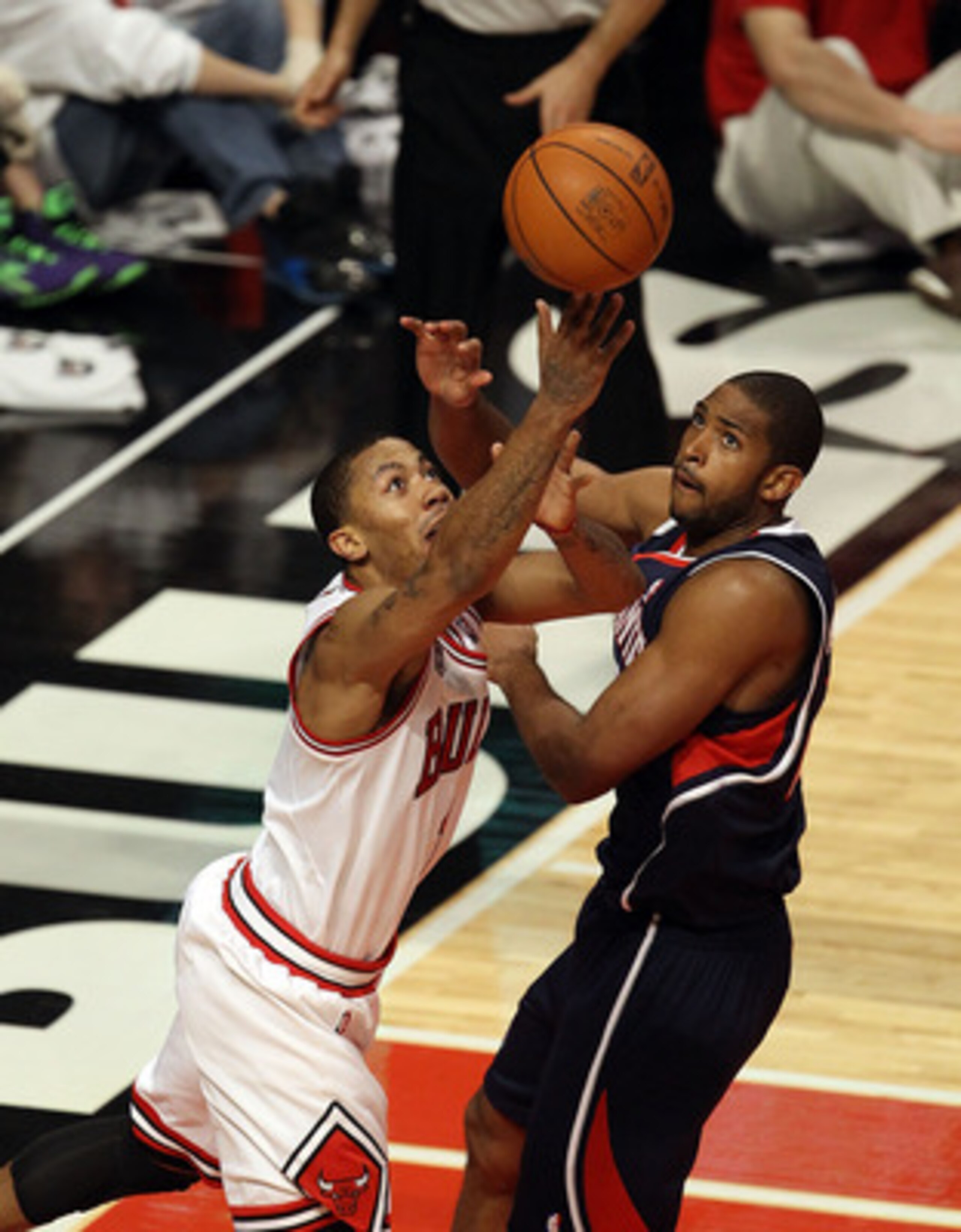 CHICAGO, IL - MARCH 11: Derrick Rose #1 of the Chicago Bulls puts up a shot against Al Horford #15 of the Atlanta Hawks on his way to a game-high 34 points at the United Center on March 11, 2011 in Chicago, Illinois. The Bulls defeated the Hawks 94-76. NO