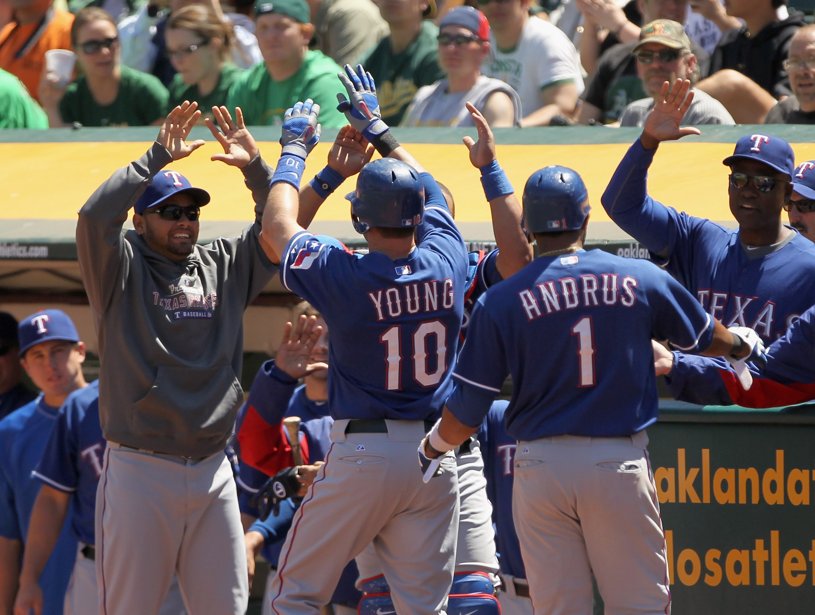OAKLAND, CA - APRIL 30: Michael Young #10 and Elvis Andrus #1 of the Texas Rangers are congratulated by teammates after Young hit a home run against the Oakland Athletics at Oakland-Alameda County Coliseum on April 30, 2011 in Oakland, California. (Phot OAKLAND, CA - APRIL 30: Michael Young #10 and Elvis Andrus #1 of the Texas Rangers are congratulated by teammates after Young hit a home run against the Oakland Athletics at Oakland-Alameda County Coliseum on April 30, 2011 in Oakland, California. (Phot