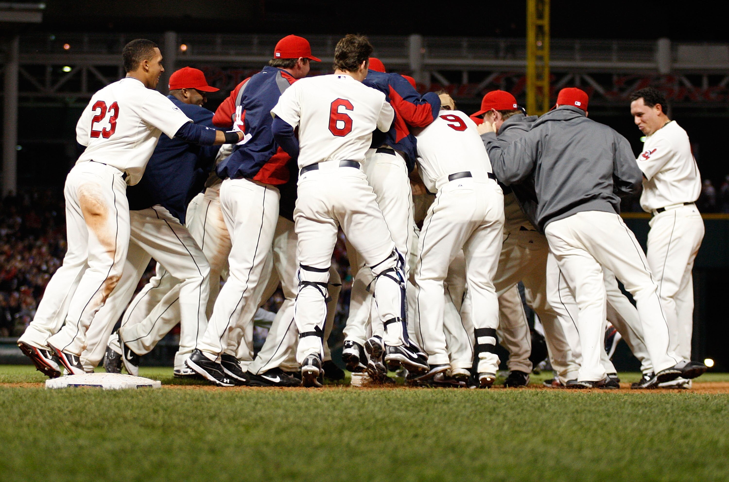 CLEVELAND - APRIL 30: Members of the Cleveland Indians mob their teammate Orlando Cabrera after he hit a walk-off game winning single in the 13th inning against the Detroit Tigers during the game on April 30, 2011 at Progressive Field in Cleveland, Ohio. CLEVELAND - APRIL 30: Members of the Cleveland Indians mob their teammate Orlando Cabrera after he hit a walk-off game winning single in the 13th inning against the Detroit Tigers during the game on April 30, 2011 at Progressive Field in Cleveland, Ohio.