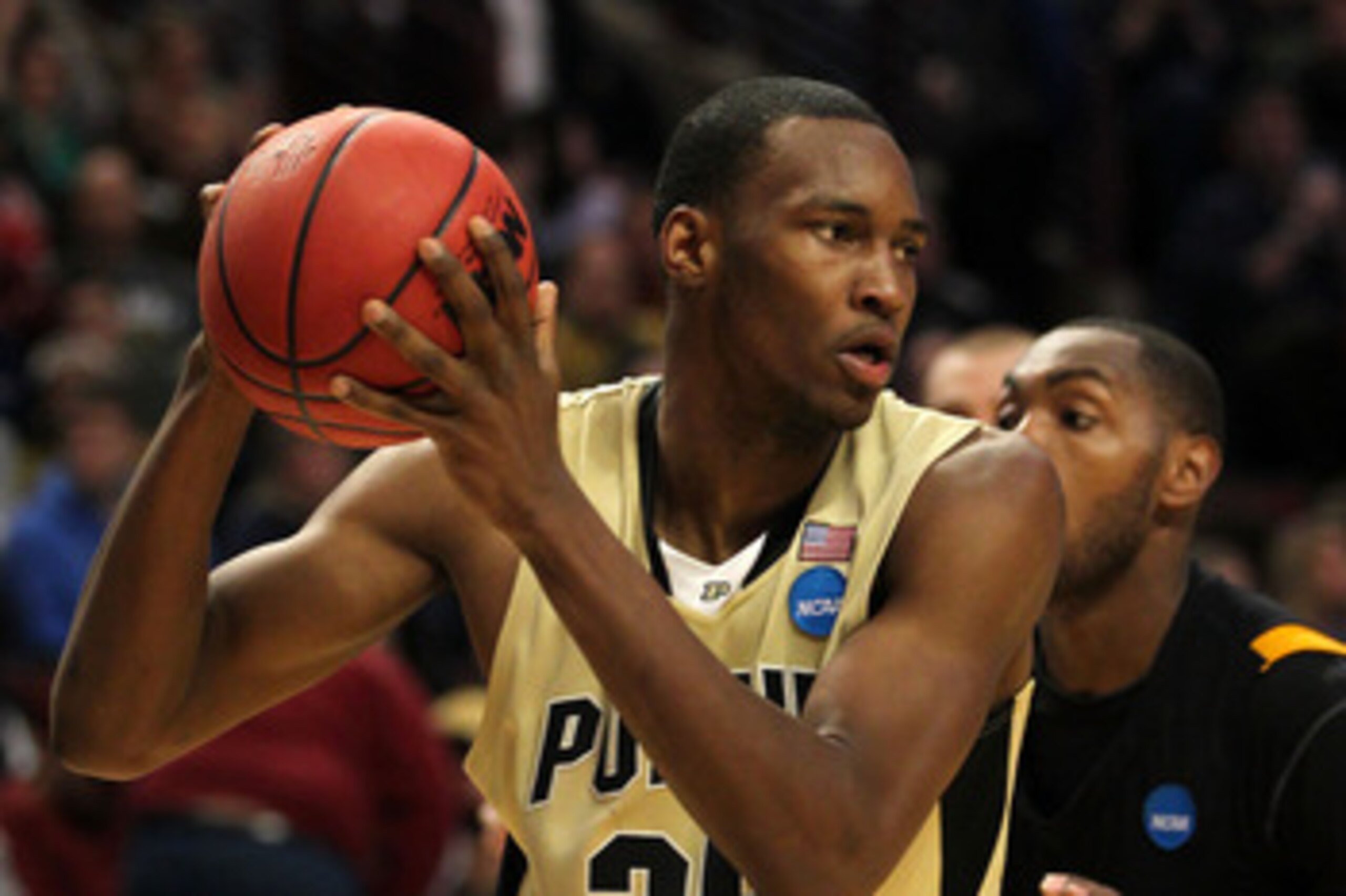 CHICAGO, IL - MARCH 20:  JaJuan Johnson #25 of the Purdue Boilermakers looks to pass against Ed Nixon #50 of the Virginia Commonwealth Rams in the second half during the third round of the 2011 NCAA men's basketball tournament at the United Center on Marc