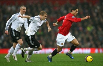 MANCHESTER, UNITED KINGDOM - DECEMBER 08:  Cristiano Ronaldo of Manchester United surges away from James McEveley of Derby County during the Barclays Premier League match between Manchester United and Derby County at Old Trafford on December 8, 2007 in Ma