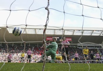 SUNDERLAND, UNITED KINGDOM - MAY 01:  Cesc Fabregas of Arsenal beats Kelvin Davies of Sunderland to score the second goal during the Barclays Premiership match between Sunderland and Arsenal at the Stadium of Light on May 1, 2006 in Sunderland, England.