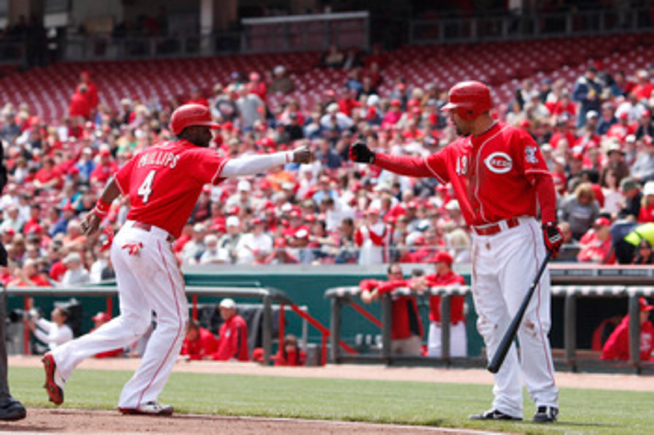 CINCINNATI, OH - APRIL 21: Brandon Phillips #4 of the Cincinnati Reds celebrates with Miguel Cairo #43 after being walked home in the first inning of the game against the Arizona Diamondbacks at Great American Ball Park on April 21, 2011 in Cincinnati, Oh CINCINNATI, OH - APRIL 21: Brandon Phillips #4 of the Cincinnati Reds celebrates with Miguel Cairo #43 after being walked home in the first inning of the game against the Arizona Diamondbacks at Great American Ball Park on April 21, 2011 in Cincinnati, Oh