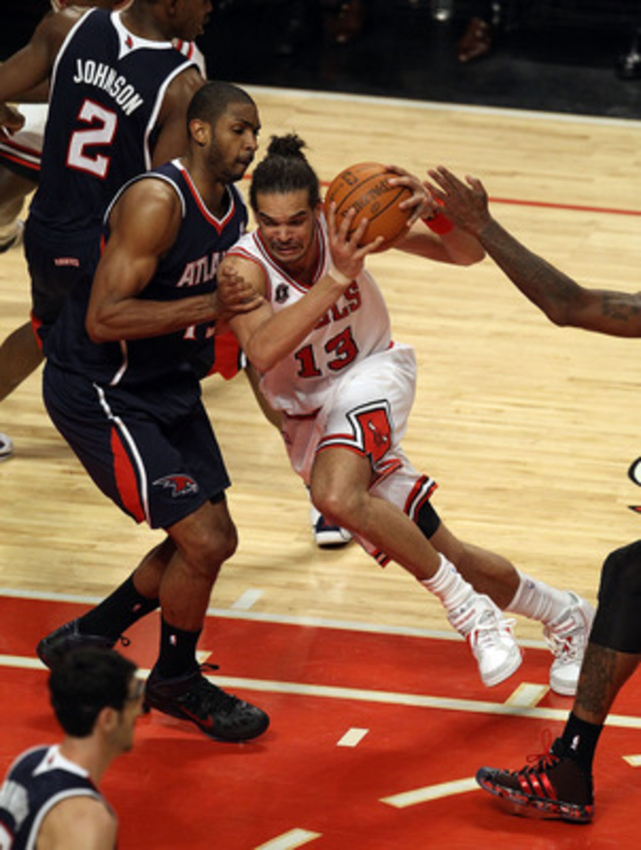 CHICAGO, IL - MARCH 11: Joakim Noah #13 of the Chicago Bulls drives against Al Horford #15 of the Atlanta Hawks at the United Center on March 11, 2011 in Chicago, Illinois. The Bulls defeated the Hawks 94-76. NOTE TO USER: User expressly acknowledges and CHICAGO, IL - MARCH 11: Joakim Noah #13 of the Chicago Bulls drives against Al Horford #15 of the Atlanta Hawks at the United Center on March 11, 2011 in Chicago, Illinois. The Bulls defeated the Hawks 94-76. NOTE TO USER: User expressly acknowledges and