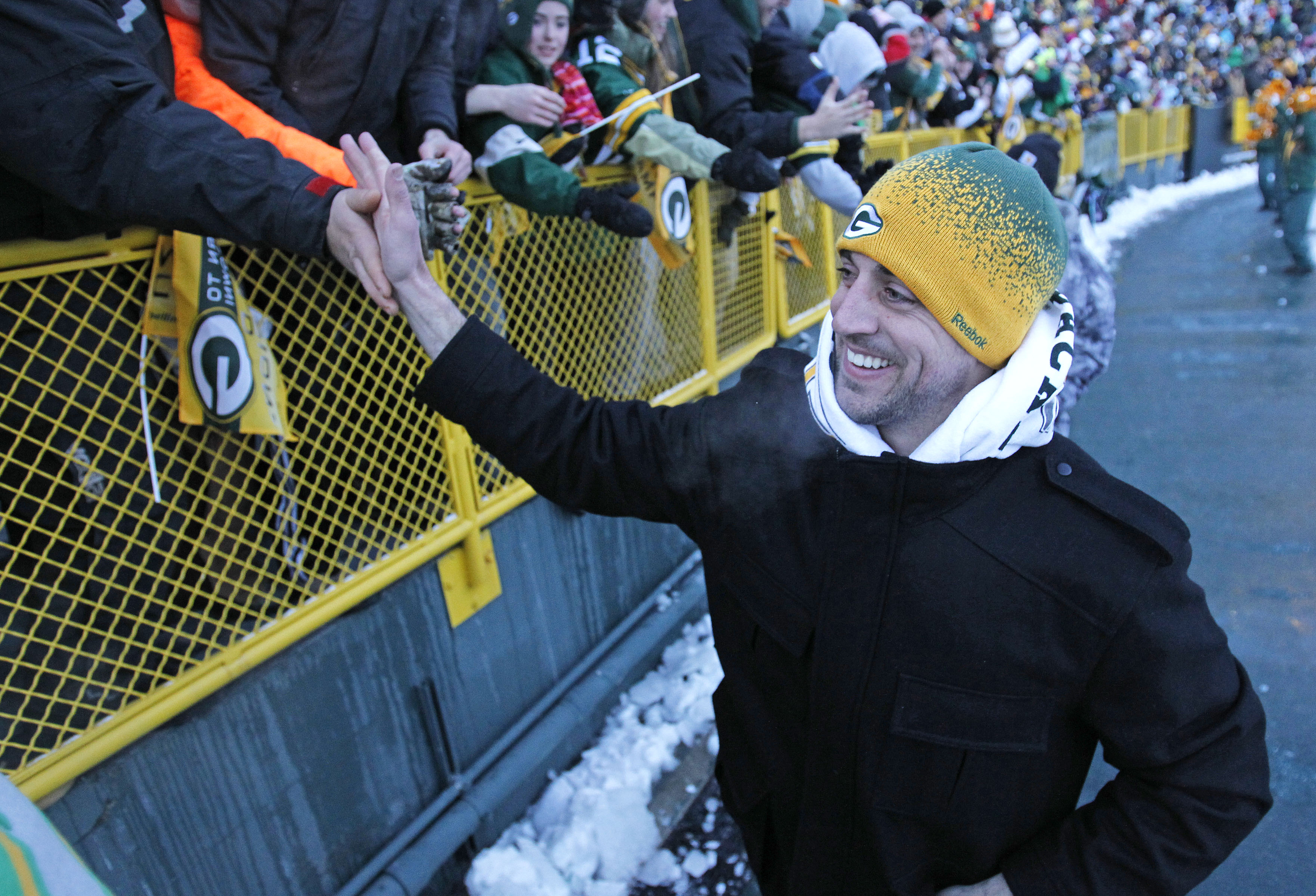 GREEN BAY, WI - FEBRUARY 08: Green Bay Packers quarterback Aaron Rodgers slaps the hands of fans as he leaves the field after the Packers victory ceremony at Lambeau Field on February 8, 2011 in Green Bay, Wisconsin.  (Photo by Matt Ludtke/Getty Images)