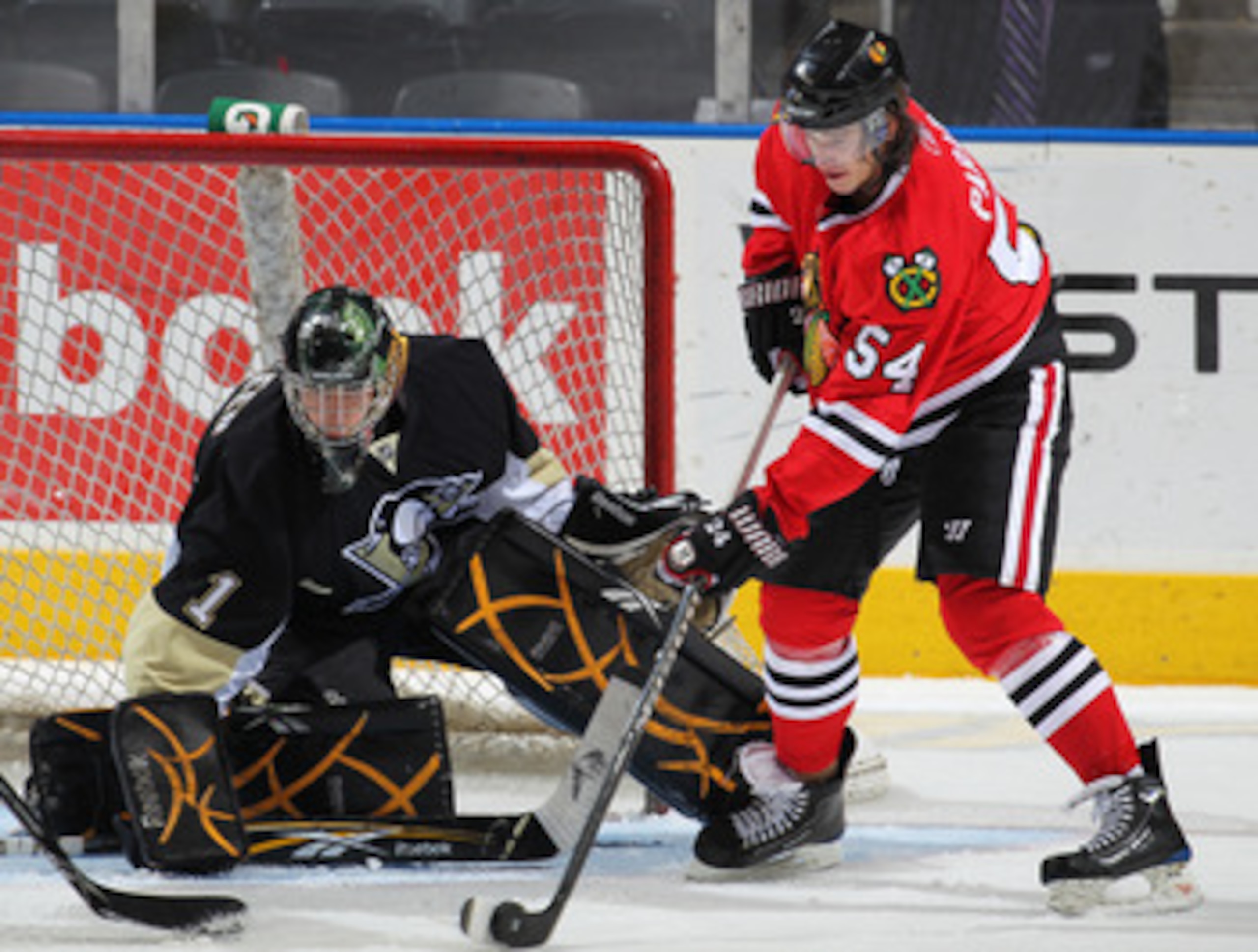 LONDON,ON - SEPTEMBER 14:  Phillipe Paradis #54 of the Chicago Black Hawks gets set to get a shot away at Patrick Killeen #1 of the Pittsburgh Penguins in a game during the NHL Rookie Tournament on September 14,2010 at the John Labatt Centre in London,Ont