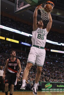 BOSTON - DECEMBER 01:  Semih Erden #86 of the Boston Celtics dunks the ball as Rudy Fernandez #5 of the Portland Trailblazers defends on December 1, 2010 at the TD Garden in Boston, Massachusetts.  NOTE TO USER: User expressly acknowledges and agrees that
