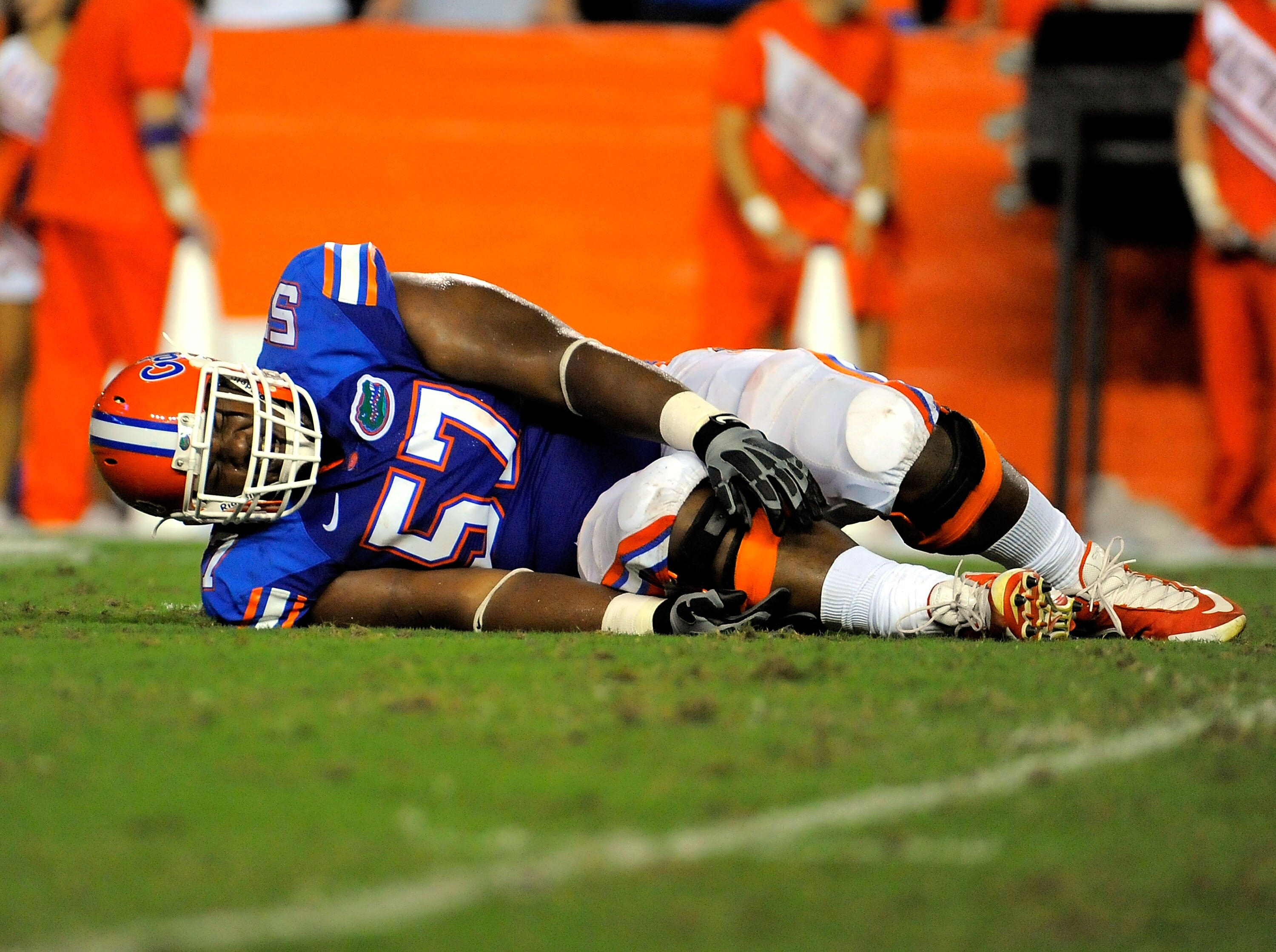 GAINESVILLE, FL - SEPTEMBER 25:  Offensive lineman Carl Johnson #57 of the Florida Gators reaches for his injured ankle while taking on the Kentucky Wildcats at Ben Hill Griffin Stadium on September 25, 2010 in Gainesville, Florida.  (Photo by Doug Benc/G