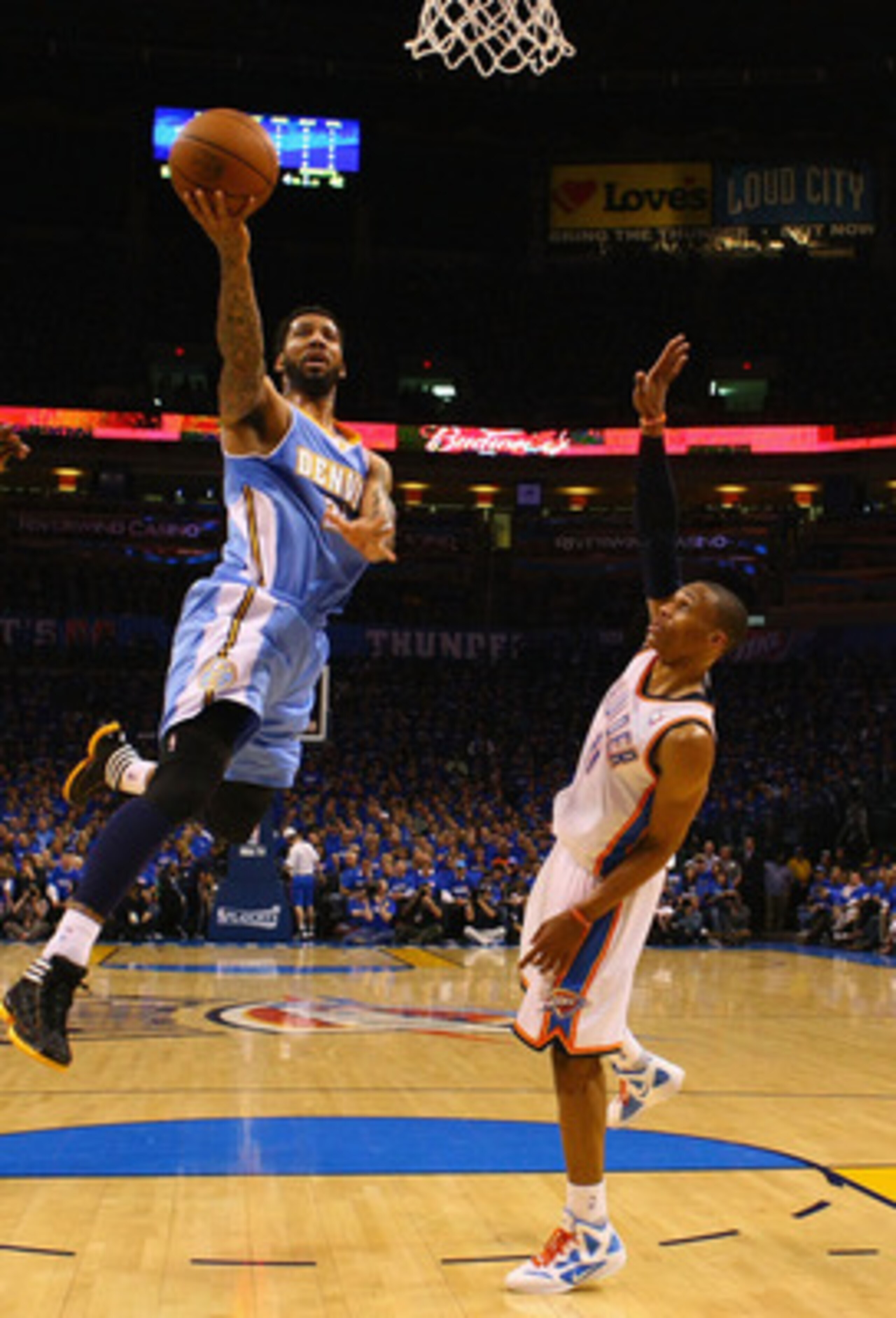 OKLAHOMA CITY, OK - APRIL 20: Wilson Chandler #21 of the Denver Nuggets drives to the basket against Russell Westbrook #0 of the Oklahoma City Thunder in Game Two of the Western Conference Quarterfinals in the 2011 NBA Playoffs on April 20, 2011 at the Fo