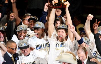 MIAMI, FL - JUNE 12:  Dirk Nowitzki #41 of the Dallas Mavericks holds up the Larry O'Brien trophy as he celebrates with his teamates and team owner Mark Cuban aftre the Mavericks won 105-95 against the Miami Heat in Game Six of the 2011 NBA Finals at Amer