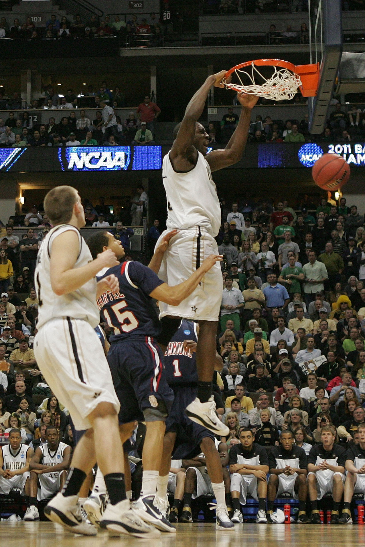 DENVER, CO - MARCH 17:  Festus Ezeli #3 of the Vanderbilt Commodores dunks the ball against Francis-Cedric Martel #15 of the Richmond Spiders during the second round of the 2011 NCAA men's basketball tournament at Pepsi Center on March 17, 2011 in Denver,