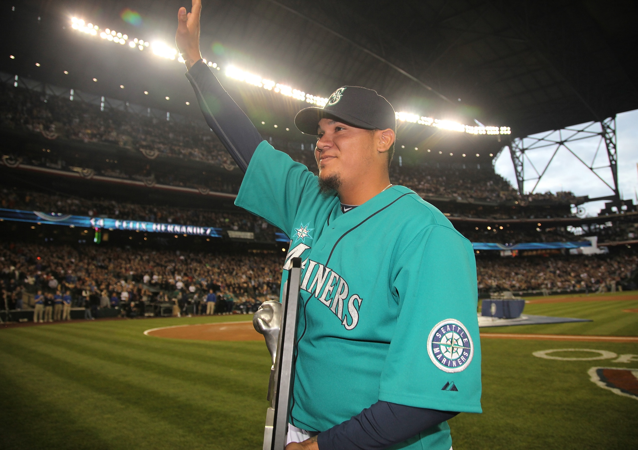 SEATTLE - APRIL 08:  Starting pitcher Felix Hernandez #34 of the Seattle Mariners waves to the crowd after receiving his American League Cy Young Award trophy prior to the Mariners' home opener against the Cleveland Indians at Safeco Field on April 8, 201