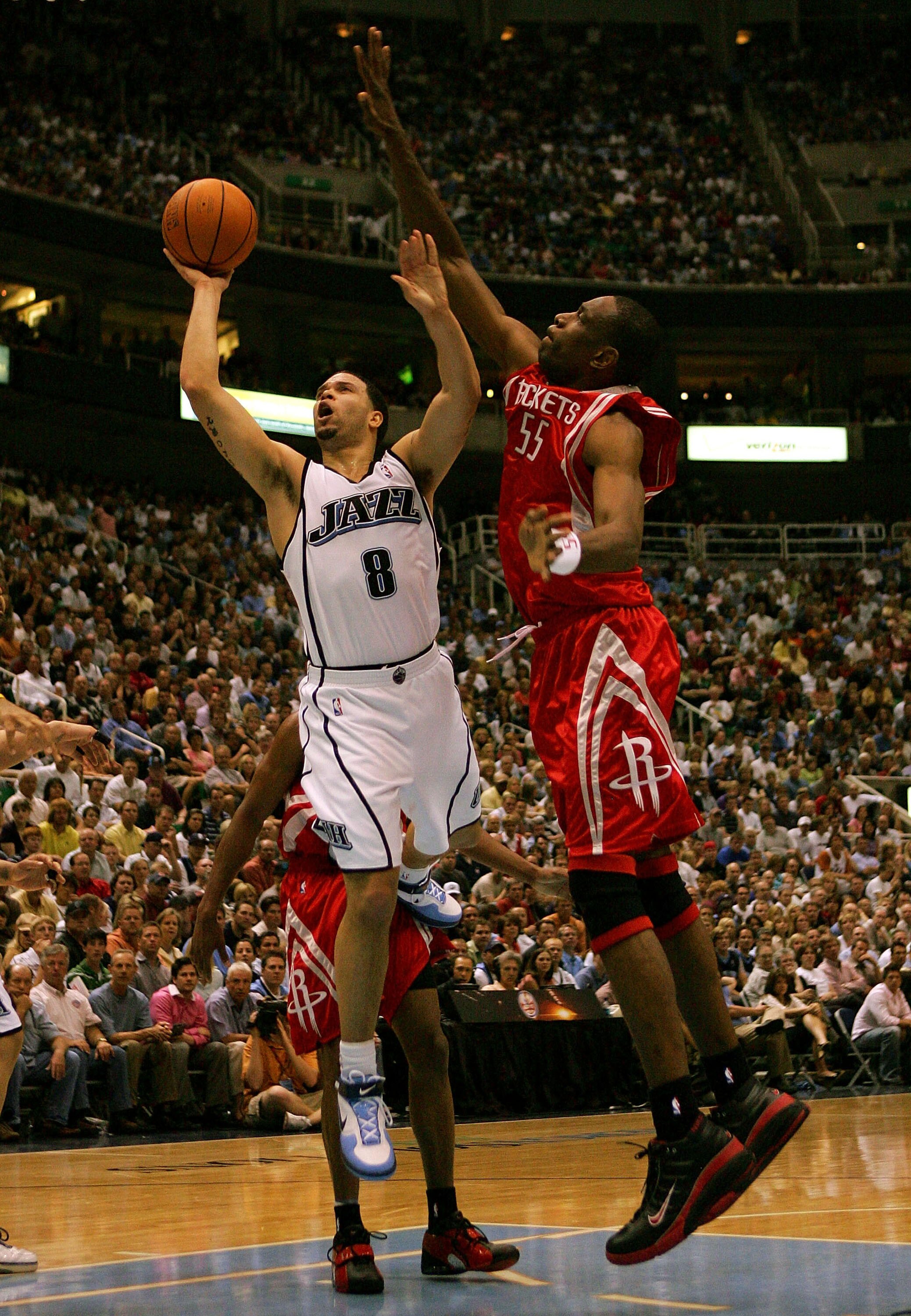 SALT LAKE CITY - APRIL 28:  Deron Williams #8 of the Utah Jazz lays up the ball over Dikembe Mutombo #55 of the Houston Rockets during Game Four of the Western Conference Quarterfinals during the 2007 NBA Playoffs at Energy Solutions Arena on April 28, 20