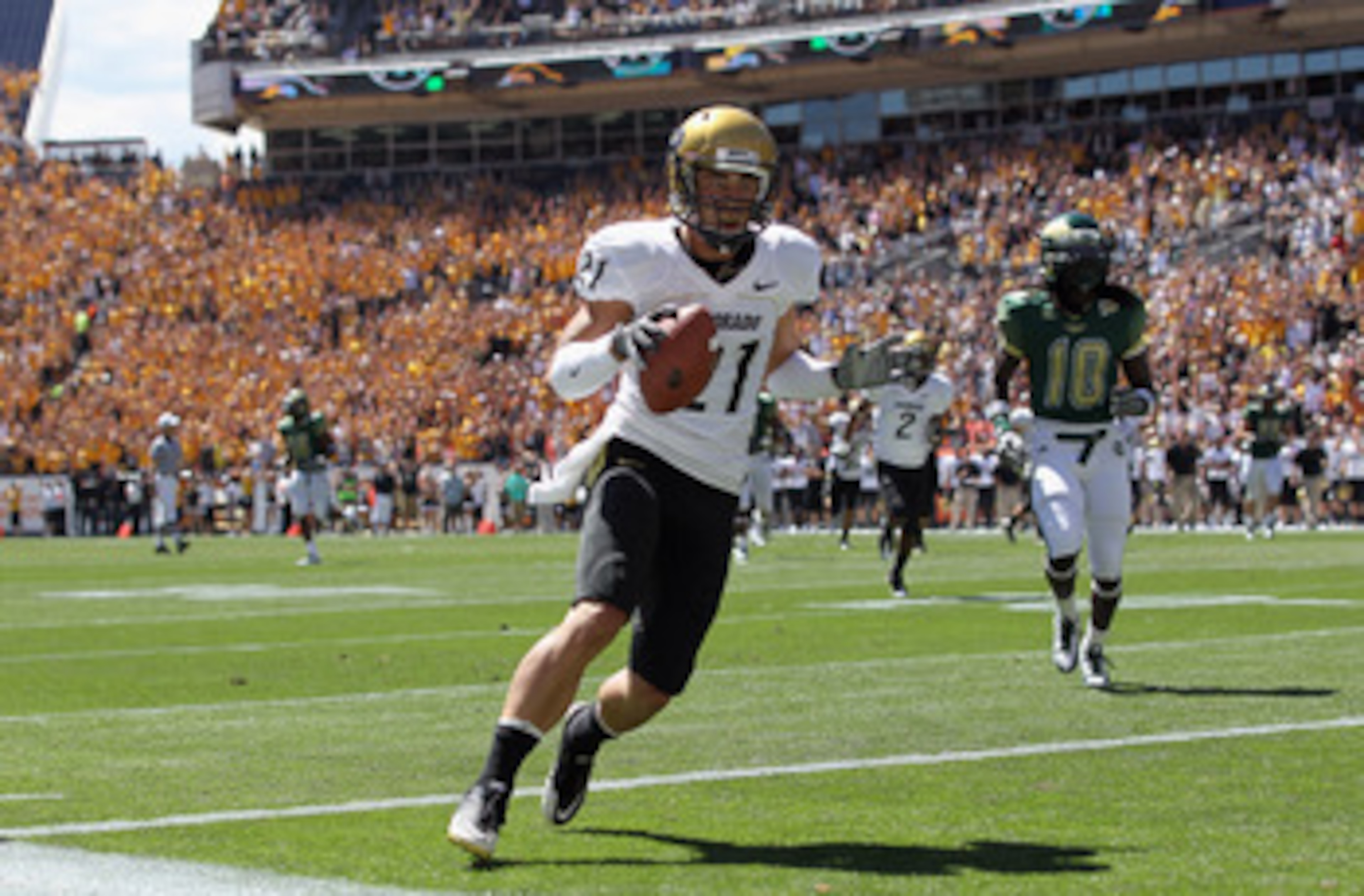 DENVER - SEPTEMBER 04:  Wide receiver Scotty McKnight #21 of the Colorado Buffaloes celebrates 27 yard touchdown reception to give the Buffs a 14-0 lead over the Colorado State Rams in the second quarter of the Rocky Mountain Showdown at INVESCO Field at