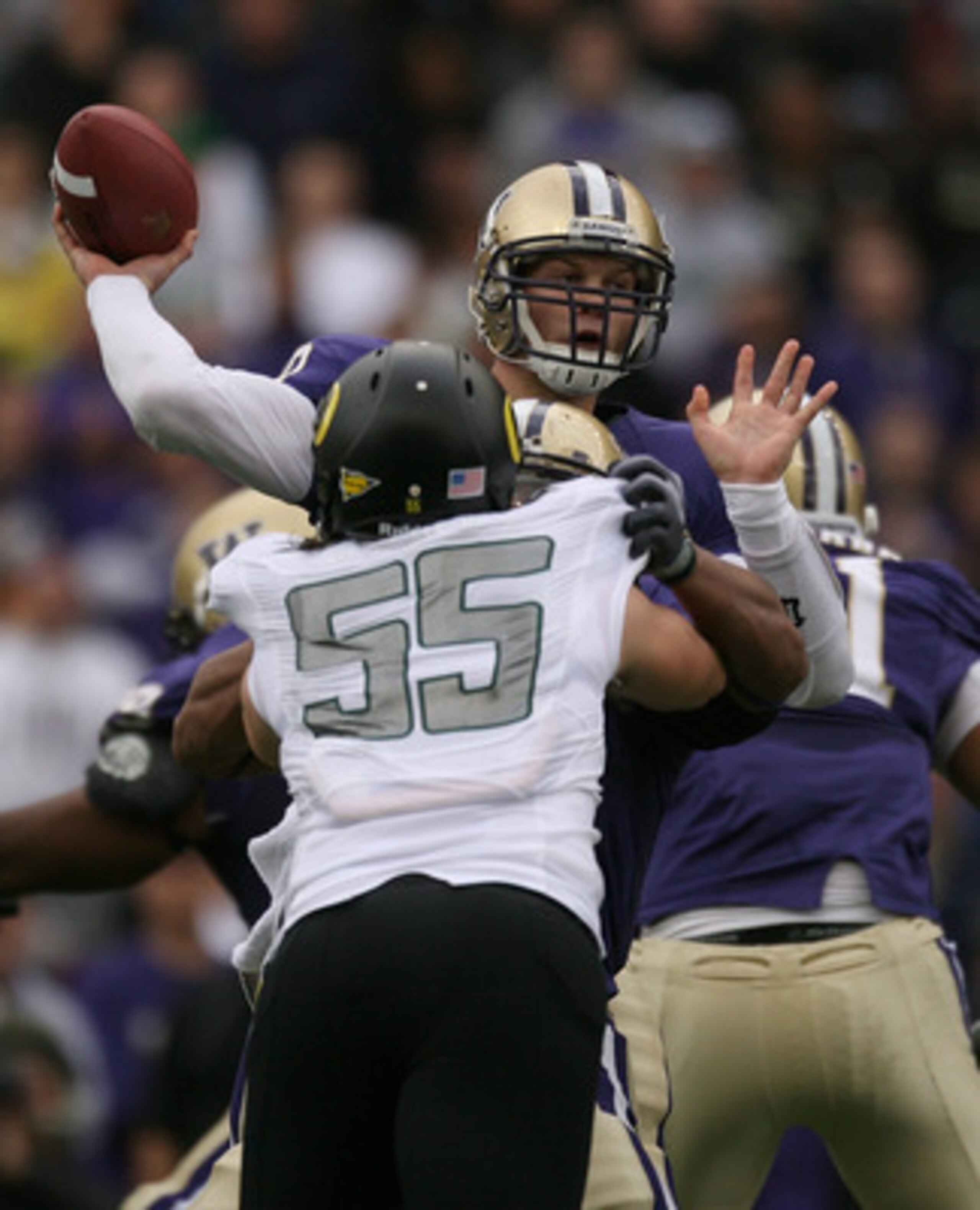 SEATTLE - OCTOBER 24:  Quarterback Jake Locker #10 of the Washington Huskies passes under pressure from Casey Matthews #55 of the Oregon Ducks on October 24, 2009 at Husky Stadium in Seattle, Washington. (Photo by Otto Greule Jr/Getty Images)