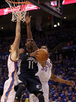OKLAHOMA CITY, OK - MAY 01:  Guard Mike Conley #11 of the Memphis Grizzlies takes a shot against Nick Collison #4 and Kevin Durant #35 of the Okalhoma City Thunder in Game One of the Western Conference Semifinals in the 2011 NBA Playoffs on May 1, 2011 at