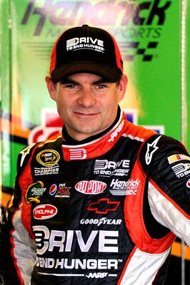 TALLADEGA, AL - APRIL 15:  Jeff Gordon, driver of the #24 Drive to End Hunger/AARP Chevrolet, stands in the garage during practice for the NASCAR Sprint Cup Series Aaron's 499 at Talladega Superspeedway on April 15, 2011 in Talladega, Alabama.  (Photo by