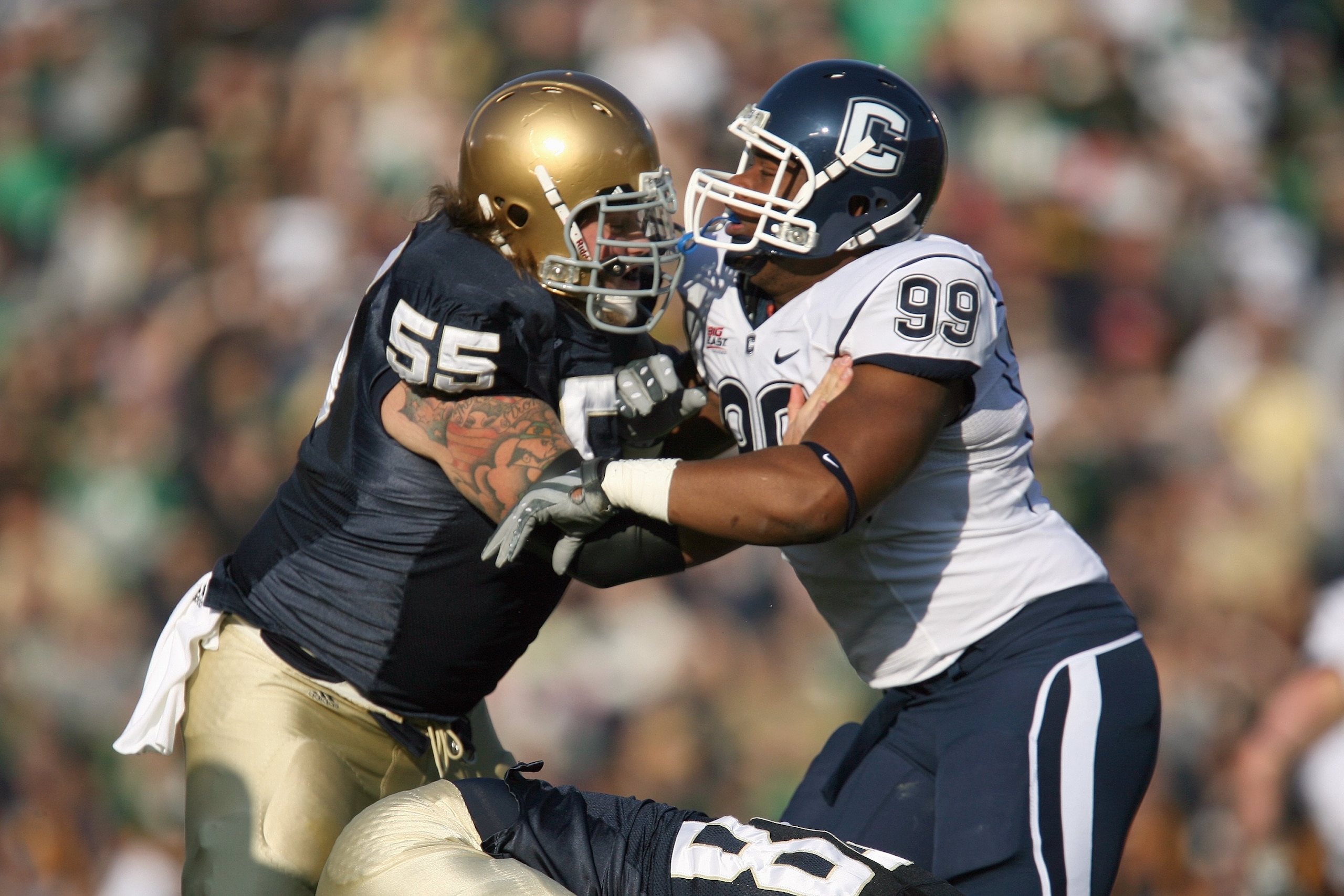 SOUTH BEND, IN - NOVEMBER 21: Guard Eric Olsen #55  of the Notre Dame Fighting Irish blocks Kendall Reyes #99 of the Univeristy of Connecticut Huskies at Notre Dame Stadium on November 21, 2009 in South Bend, Indiana. (Photo by Jonathan Daniel/Getty Image