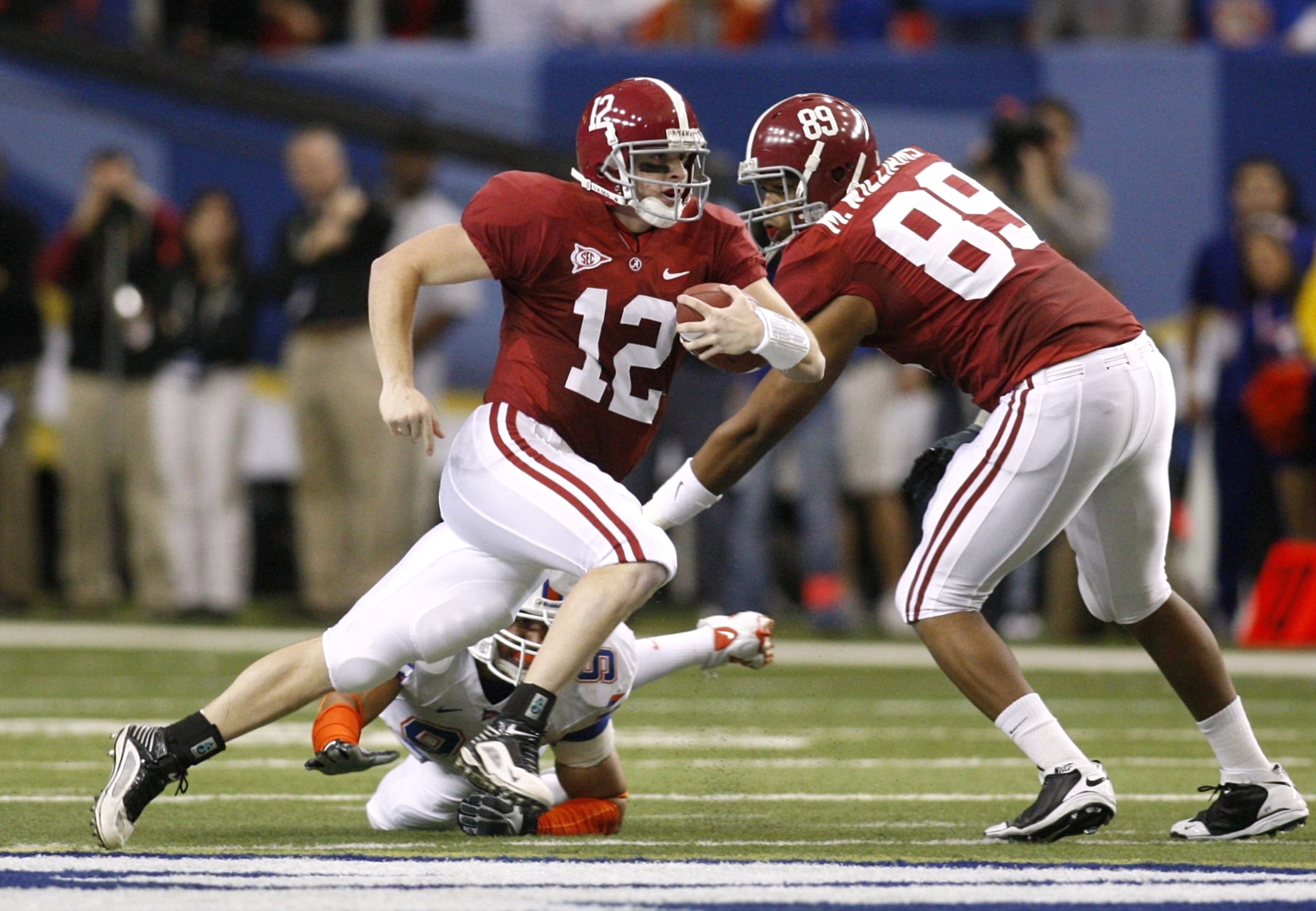 ATLANTA - DECEMBER 5:  Quarterback Greg McElroy #12 of the Alabama Crimson Tide runs with the ball in the first quarter against the Florida Gators during the SEC Championship game at Georgia Dome on December 5, 2009 in Atlanta, Georgia.  (Photo by Chris G
