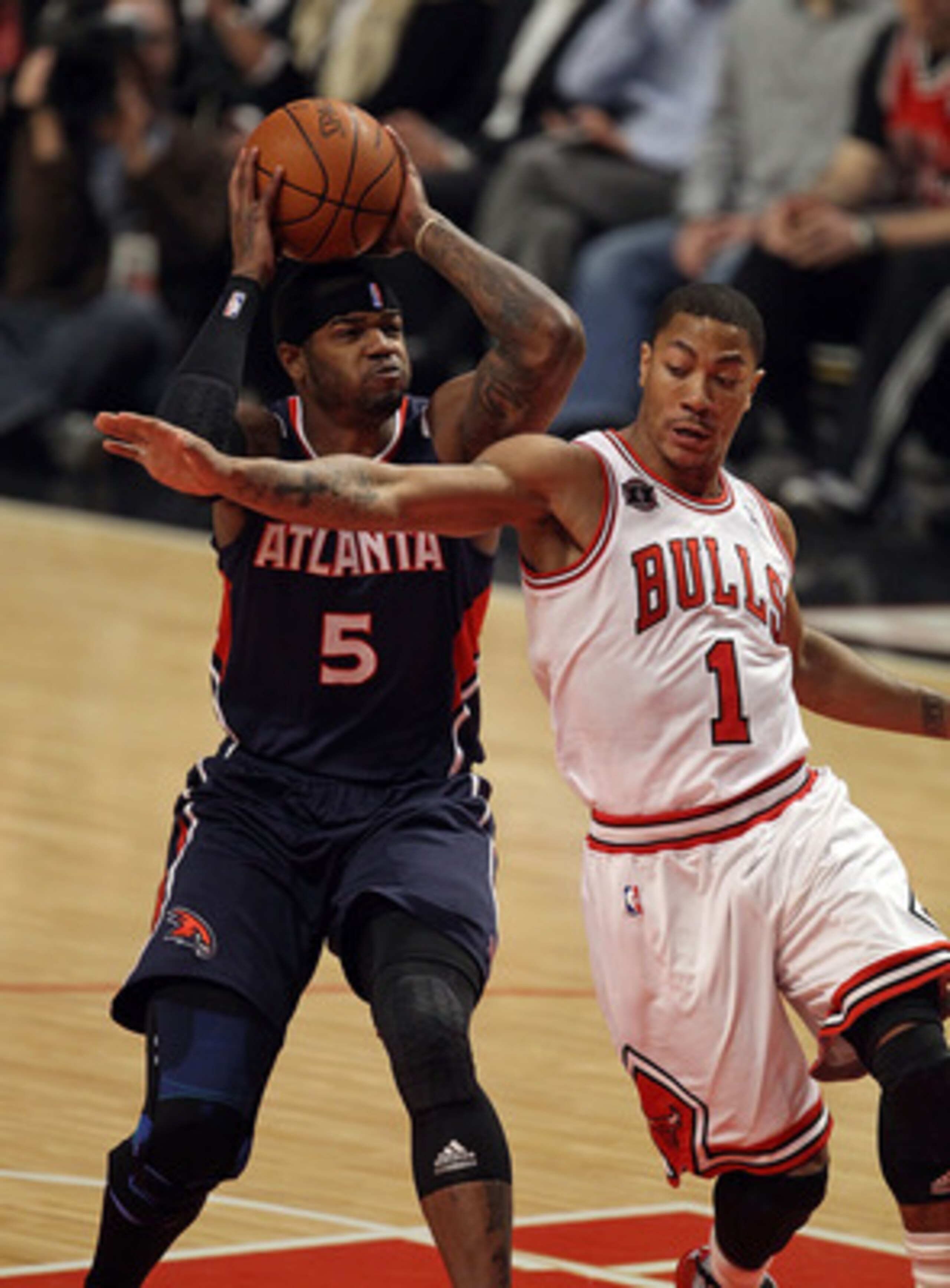 CHICAGO, IL - MARCH 11: Josh Smith #5 of the Atlanta Hawks puts up a shot over Derrick Rose #1 of the Chicago Bulls at the United Center on March 11, 2011 in Chicago, Illinois. The Bulls defeated the Hawks 94-76. NOTE TO USER: User expressly acknowledges CHICAGO, IL - MARCH 11: Josh Smith #5 of the Atlanta Hawks puts up a shot over Derrick Rose #1 of the Chicago Bulls at the United Center on March 11, 2011 in Chicago, Illinois. The Bulls defeated the Hawks 94-76. NOTE TO USER: User expressly acknowledges