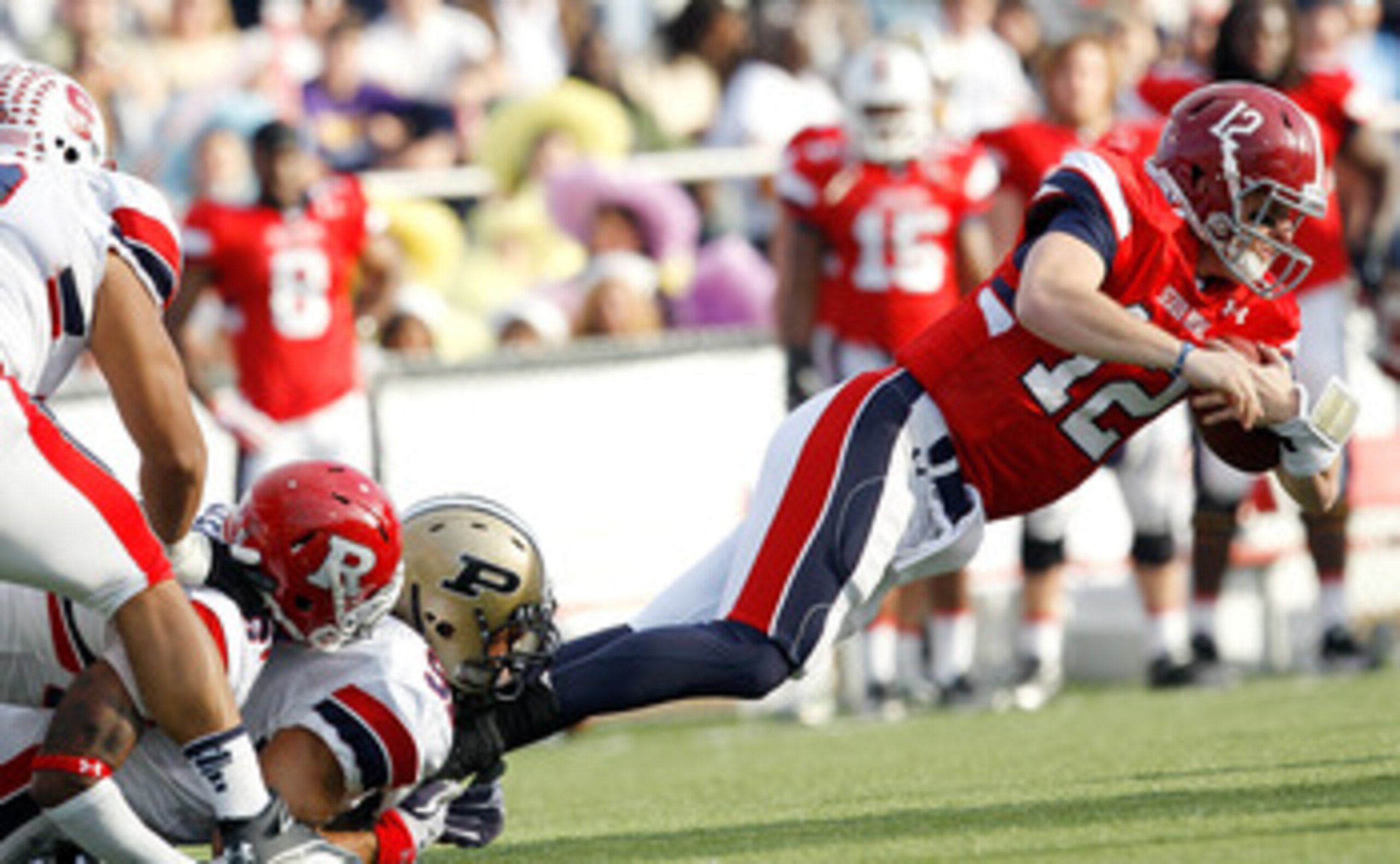 MOBILE, AL - JANUARY 29: Quarterback Greg McElroy #12 of the South Team is tackled by Ryan Kerrigan #91 and Joe Lefeged #26 of the North Team during the second quarter of the Under Armour Senior Bowl January 29, 2011 at Ladd Peebles Stadium in Mobile, Ala