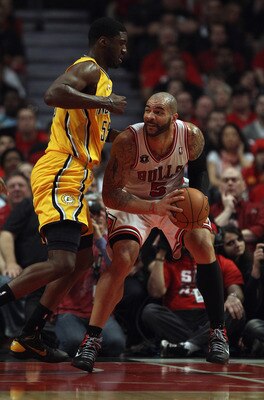 CHICAGO, IL - APRIL 26: Carlos Boozer #5 of the Chicago Bulls moves against Roy Hibbert #55 of the Indiana Pacers in Game Five of the Eastern Conference Quarterfinals in the 2011 NBA Playoffs at the United Center on April 26, 2011 in Chicago, Illinois. Th