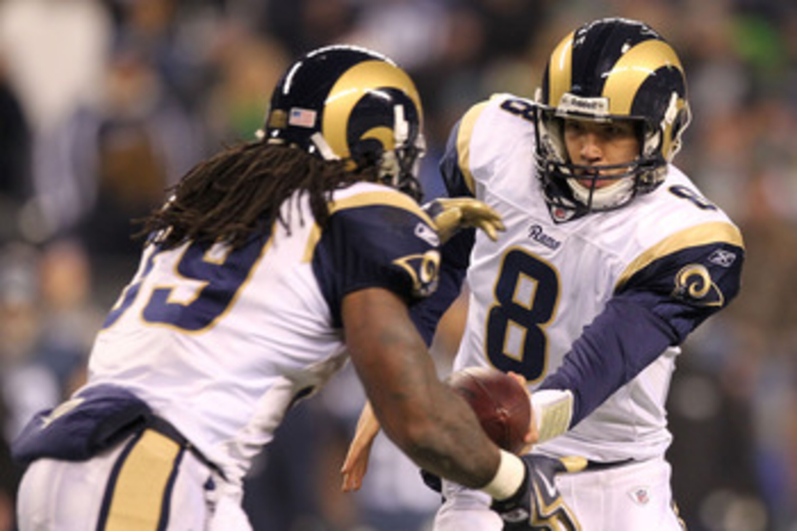 SEATTLE, WA - JANUARY 02:  Quarterback Sam Bradford #8 of the St. Louis Rams hands the ball off to running back Steven Jackson #39 during their game against the Seattle Seahawks at Qwest Field on January 2, 2011 in Seattle, Washington.  (Photo by Otto Gre