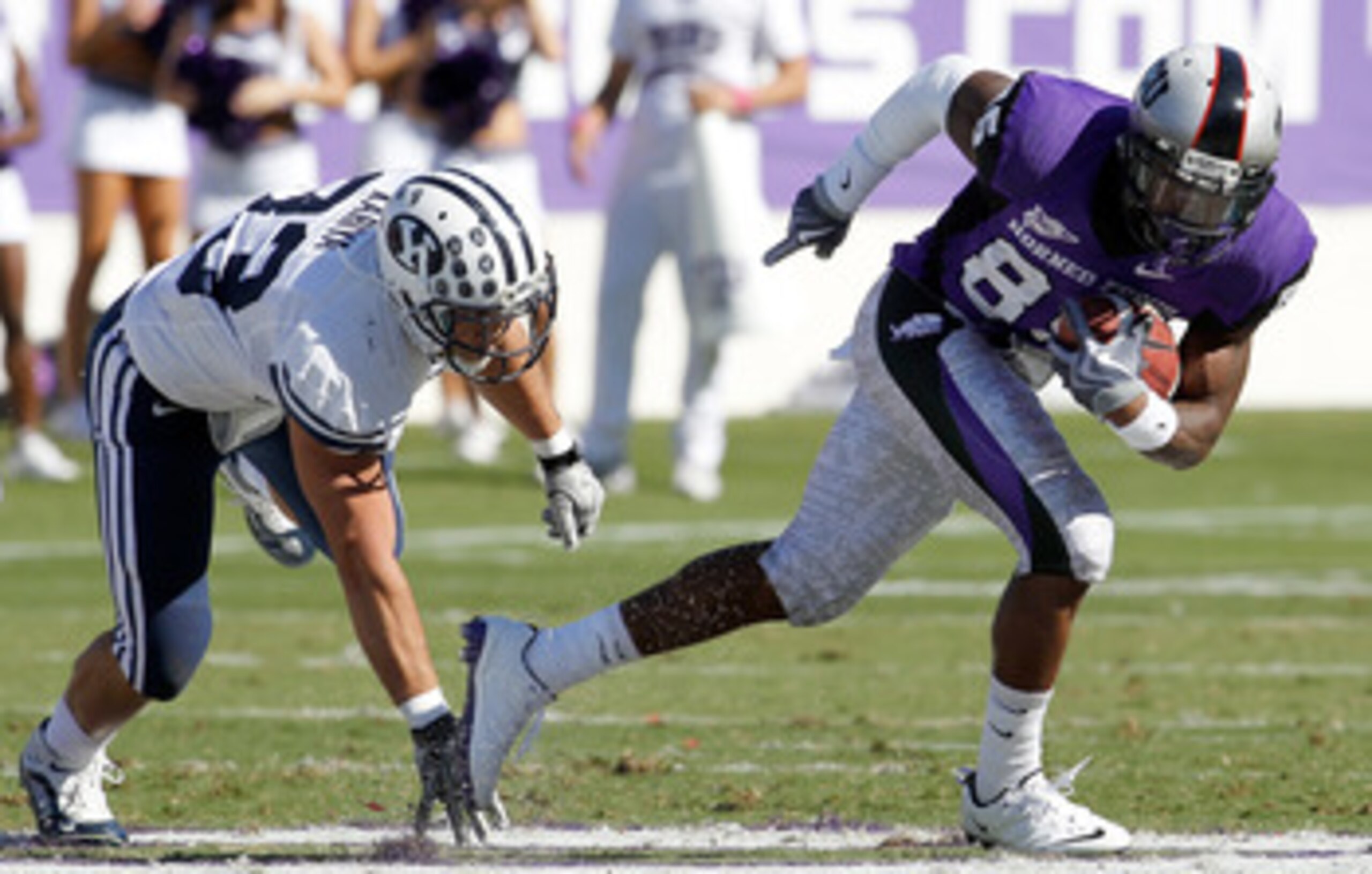 FORT WORTH, TX - OCTOBER 16:  Wide receiver Jeremy Kerley #85 of the TCU Horned Frogs carries the ball against defensice back Bryan Kariya #33 of the BYU Cougars at Amon G. Carter Stadium on October 16, 2010 in Fort Worth, Texas.  TCU beat BYU 31-3.  (Pho