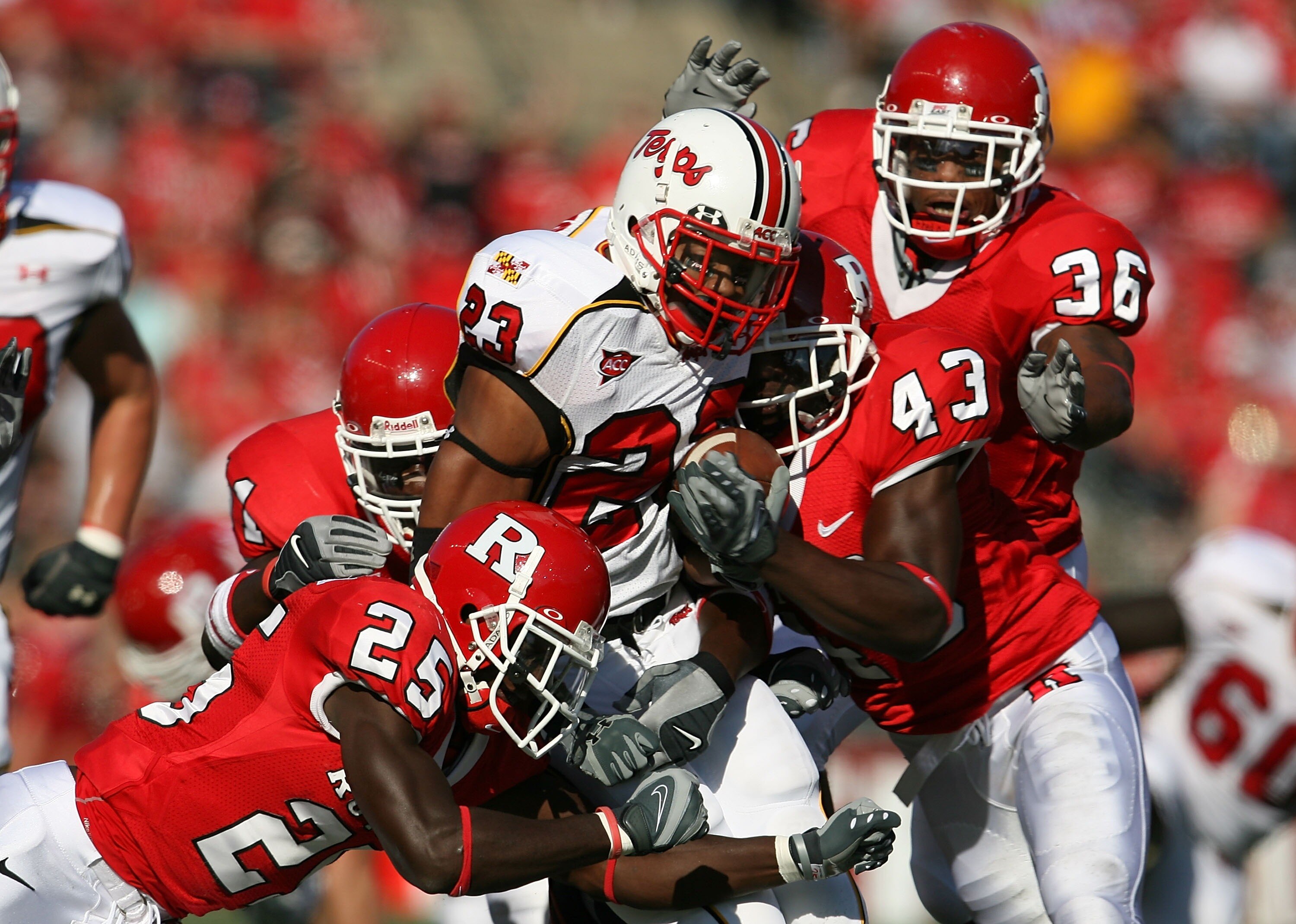 PISCATAWAY, NJ - SEPTEMBER 29: Jason McCourty #25 and Ron Girault #43 of the Rutgers Scarlet Knights tackle Da'Rel Scott #23 of the Maryland Terrapins during their game at Rutgers Stadium on September 29, 2007 in Piscataway, New Jersey. (Photo by Nick Lah