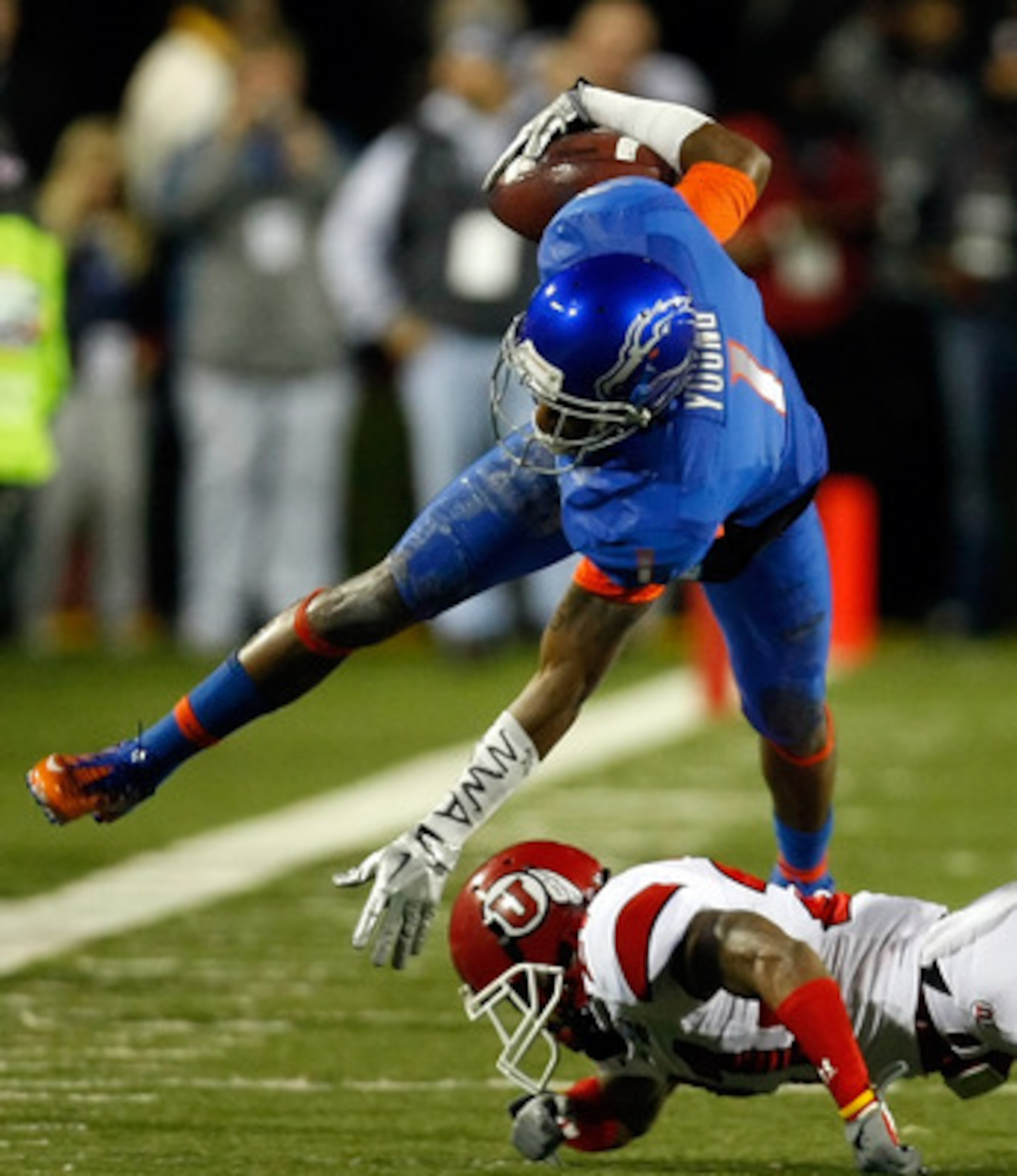 LAS VEGAS, NV - DECEMBER 22: Titus Young #1 of the Boise State Broncos is tripped up by Brian Blechen #2 of the Utah Utes during the MAACO Bowl Las Vegas at Sam Boyd Stadium December 22, 2010 in Las Vegas, Nevada. (Photo by Ethan Miller/Getty Images) LAS VEGAS, NV - DECEMBER 22: Titus Young #1 of the Boise State Broncos is tripped up by Brian Blechen #2 of the Utah Utes during the MAACO Bowl Las Vegas at Sam Boyd Stadium December 22, 2010 in Las Vegas, Nevada. (Photo by Ethan Miller/Getty Images)