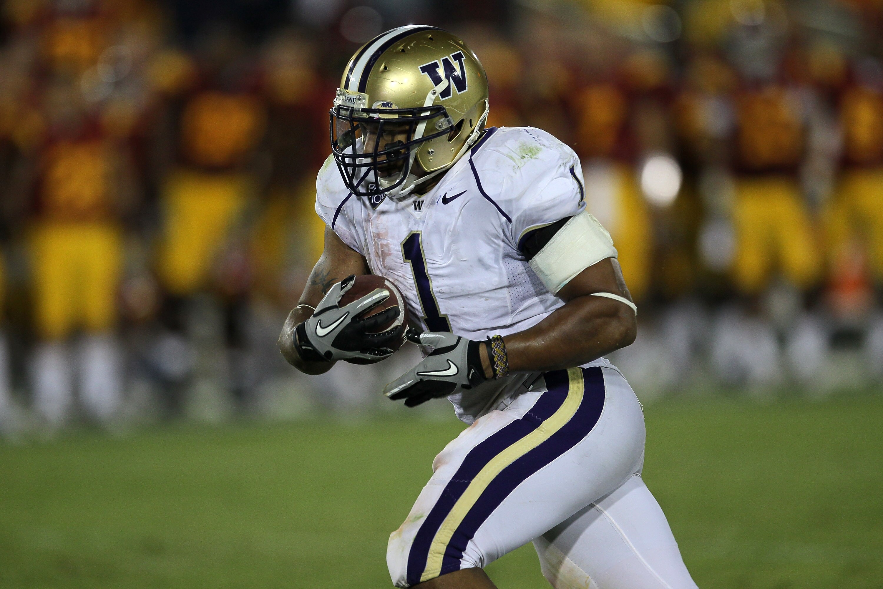 LOS ANGELES - OCTOBER 2:  Running back Chris Polk  of the Washington Huskies carries the ball against the USC Trojans at the Los Angeles Memorial Coliseum on October 2, 2010 in Los Angeles, California.  Washington won 32-31.   (Photo by Stephen Dunn/Getty