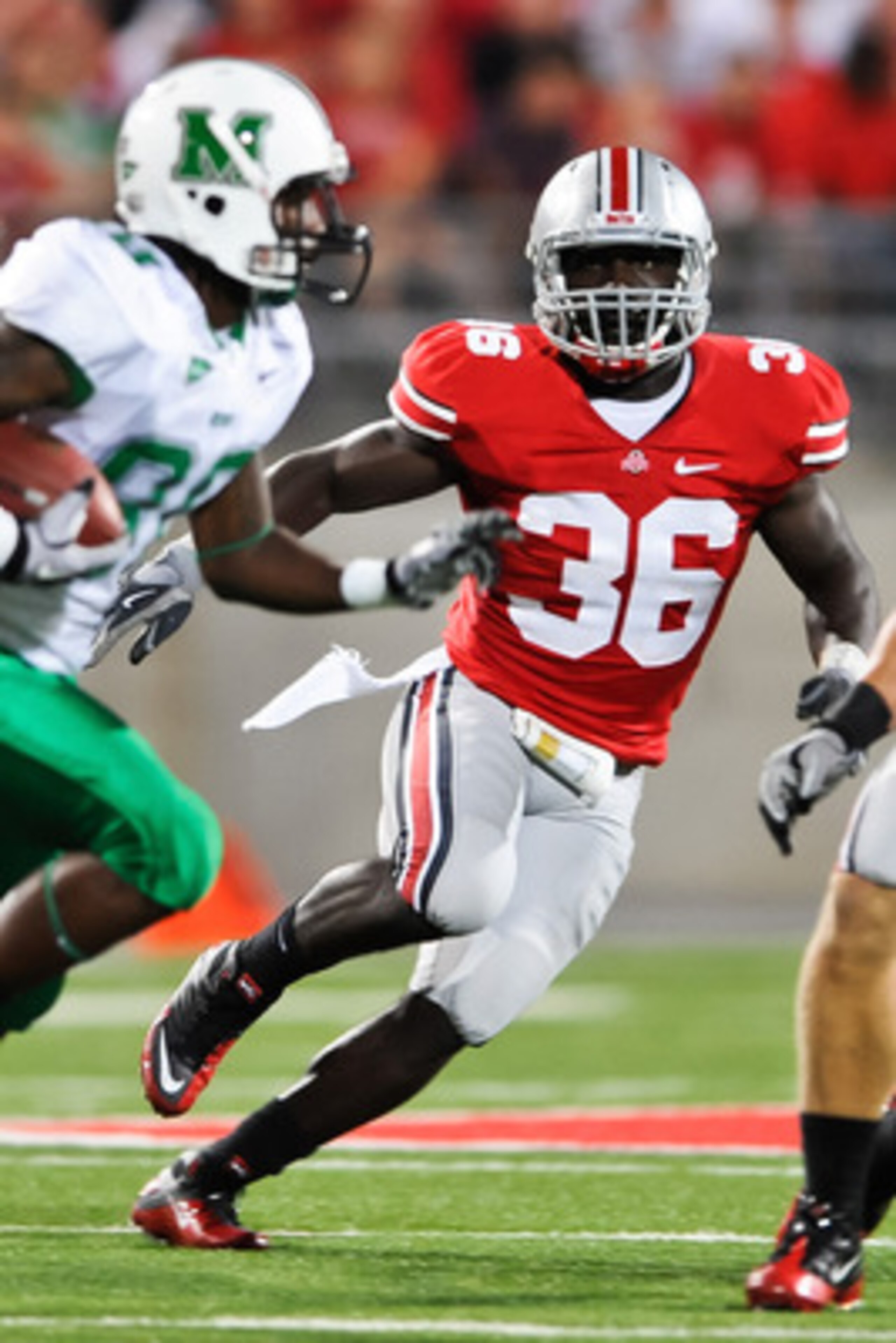 COLUMBUS, OH - SEPTEMBER 2: Brian Rolle #36 of the Ohio State Buckeyes pursues ballcarrier Courtney Edmonson #80 of the Marshall Thundering Herd at Ohio Stadium on September 2, 2010 in Columbus, Ohio. (Photo by Jamie Sabau/Getty Images)