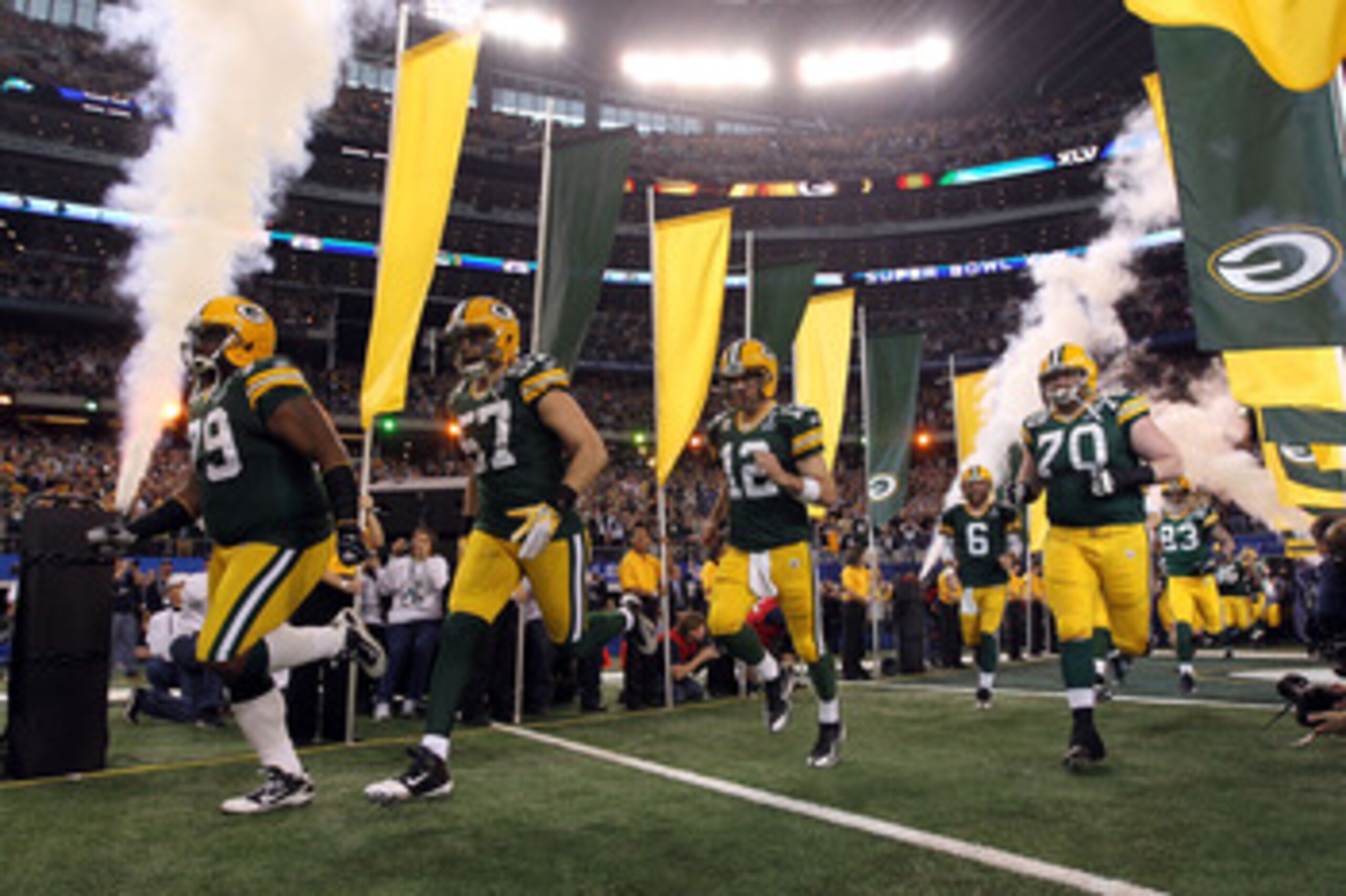 ARLINGTON, TX - FEBRUARY 06: Ryan Pickett #79, Matt Wilhelm #57, Aaron Rodgers #12 and T.J. Lang #70 of the Green Bay Packers runs out of the tunnel to take on the Pittsburgh Steelers during Super Bowl XLV at Cowboys Stadium on February 6, 2011 in Arling ARLINGTON, TX - FEBRUARY 06: Ryan Pickett #79, Matt Wilhelm #57, Aaron Rodgers #12 and T.J. Lang #70 of the Green Bay Packers runs out of the tunnel to take on the Pittsburgh Steelers during Super Bowl XLV at Cowboys Stadium on February 6, 2011 in Arling