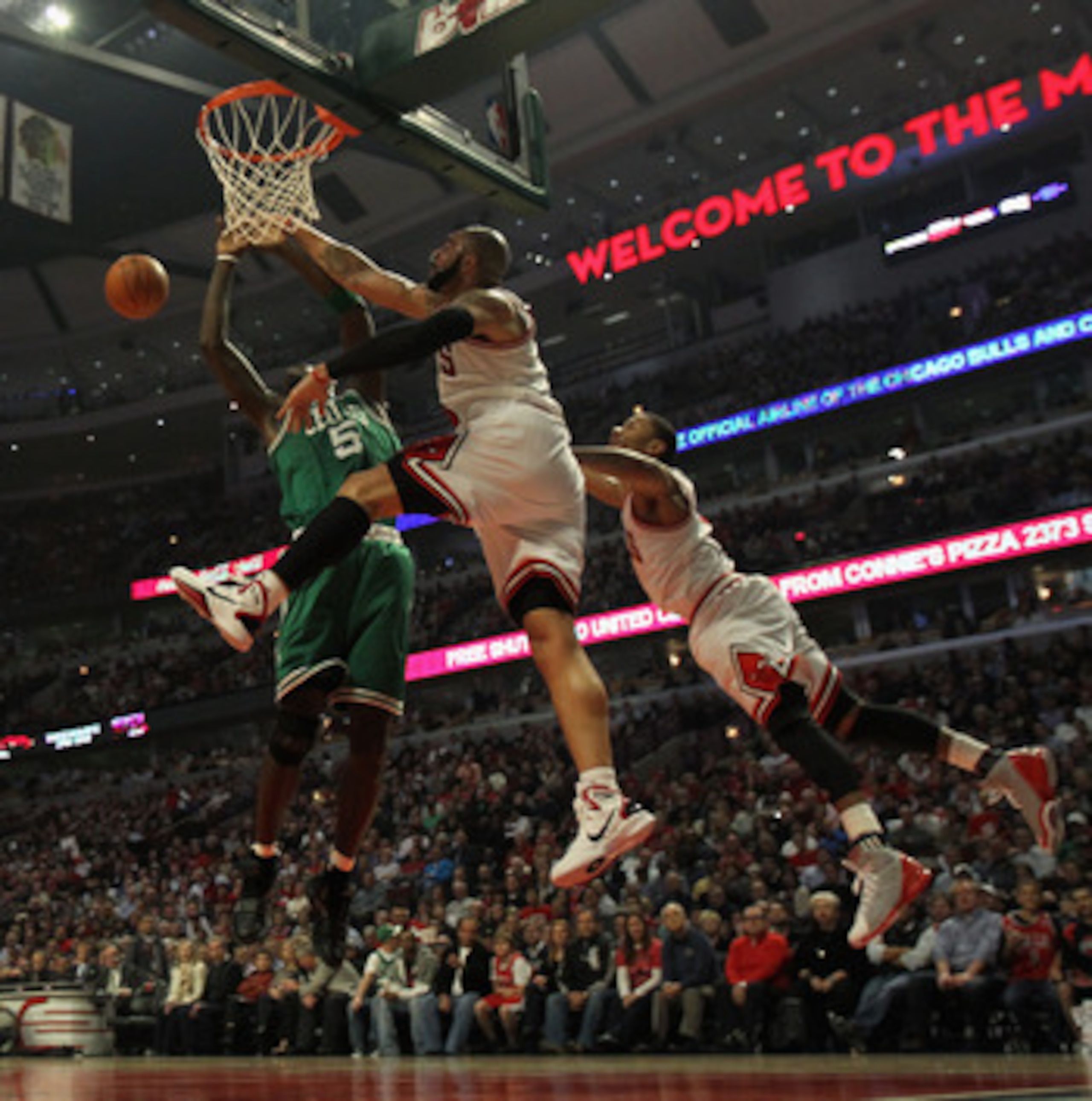 CHICAGO, IL - APRIL 07: Derrick Rose #1 (R) and Carlos Boozer #5 of the Chicago Bulls leap to block a shot by Kevin Garnett #5 of the Boston Celtics at United Center on April 7, 2011 in Chicago, Illinois. NOTE TO USER: User expressly acknowledges and agre