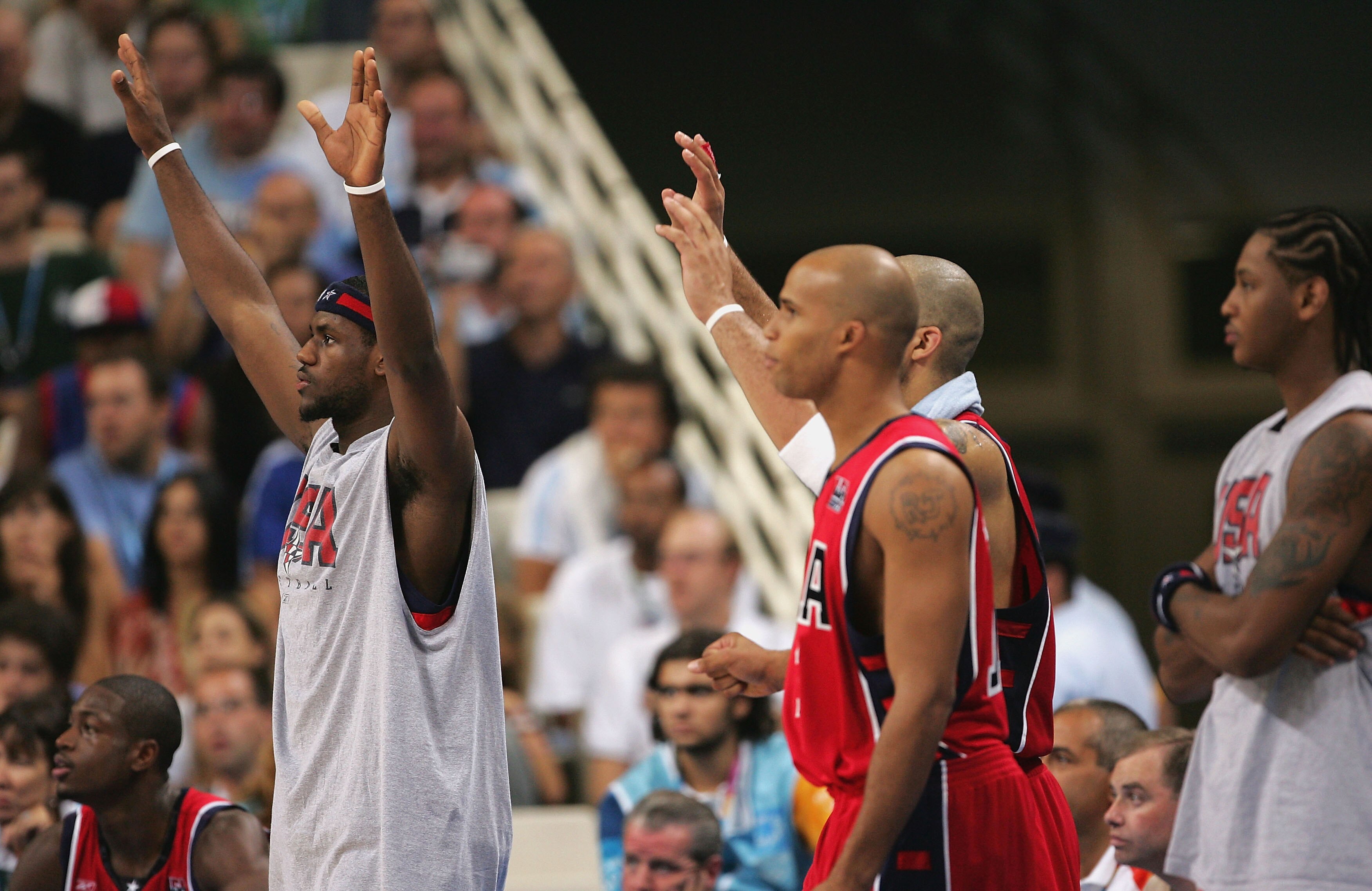ATHENS - AUGUST 28:  LeBron James #9 (front), Richard Jefferson #15 and Carmelo Anthony cheer for the United States team from the bench as they go on to win the men's basketball bronze medal contest game 104 - 96 over Lithuania on August 28, 2004 during t