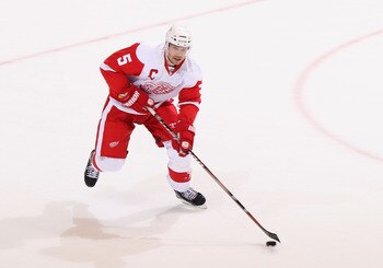 GLENDALE, AZ - APRIL 18:  Nicklas Lidstrom #5 of the Detroit Red Wings skates with the puck in Game Three of the Western Conference Quarterfinals against the Phoenix Coyotes during the 2011 NHL Stanley Cup Playoffs at Jobing.com Arena on April 18, 2011 in