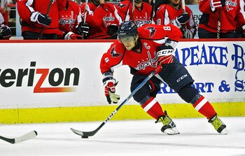 WASHINGTON , DC - APRIL 23:  Alex Ovechkin #8 of the Washington Capitals skates the puck across the blue line against the New York Rangers in Game Five of the Eastern Conference Quarterfinals during the 2011 NHL Stanley Cup Playoffs at the Verizon Center 