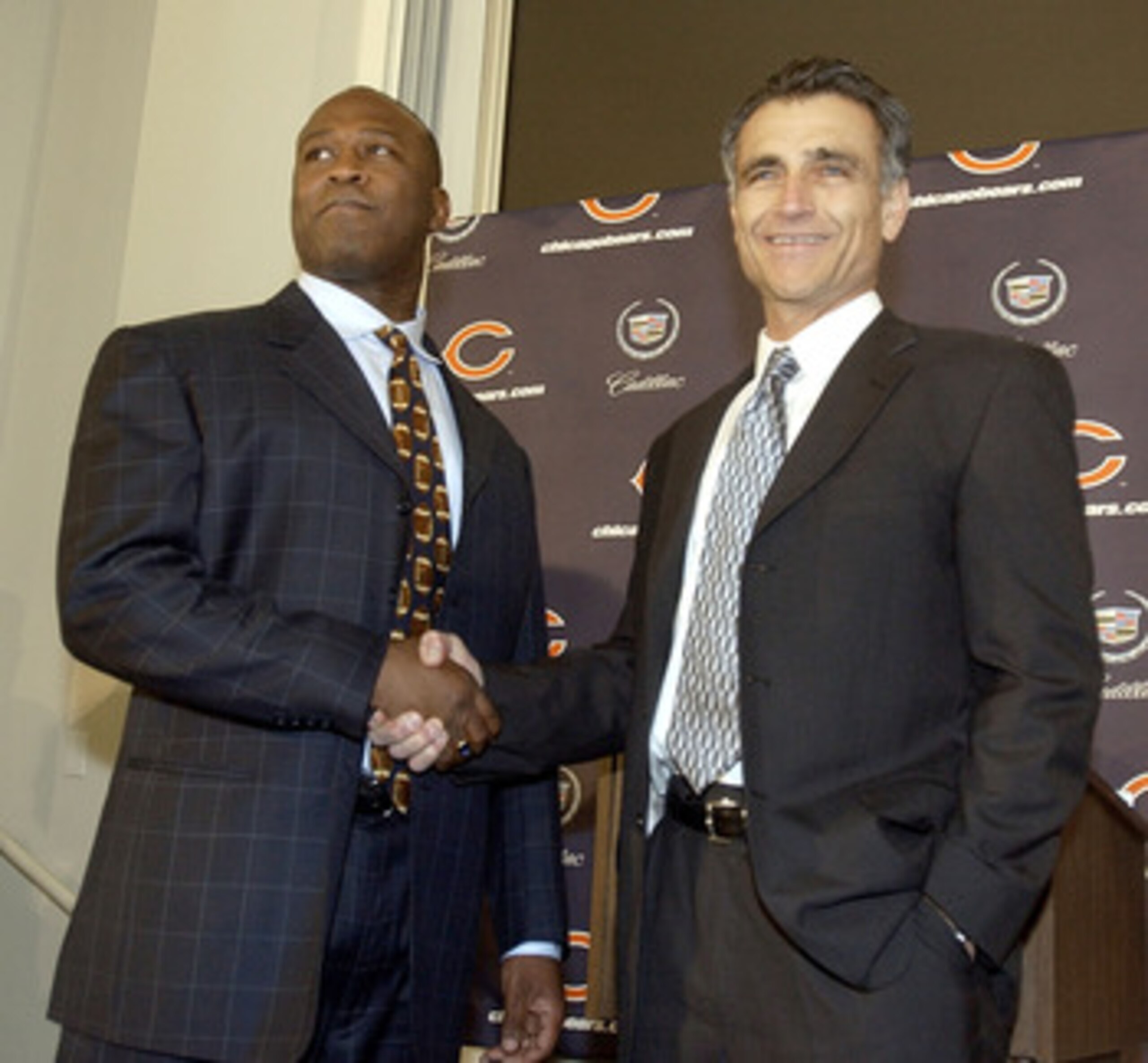 LIBERTYVILLE, IL - JANUARY 15:  Chicago Bears General Manager Jerry Angelo (R) congratulates former defensive coordinator for the St. Louis Rams, Lovie Smith (L), on his four year contract as head coach of the Chicago Bears at a media conference on Januar