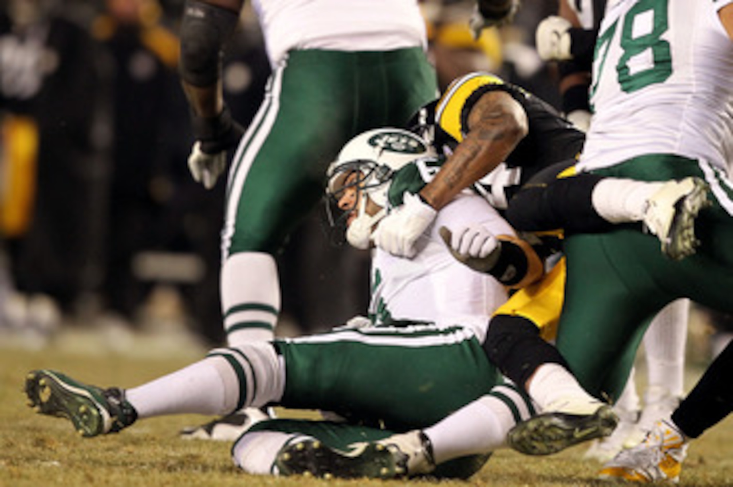 PITTSBURGH, PA - JANUARY 23:  Mark Sanchez #6 of the New York Jets gets hit by Ike Taylor #24 of the Pittsburgh Steelers during the 2011 AFC Championship game at Heinz Field on January 23, 2011 in Pittsburgh, Pennsylvania.  (Photo by Al Bello/Getty Images