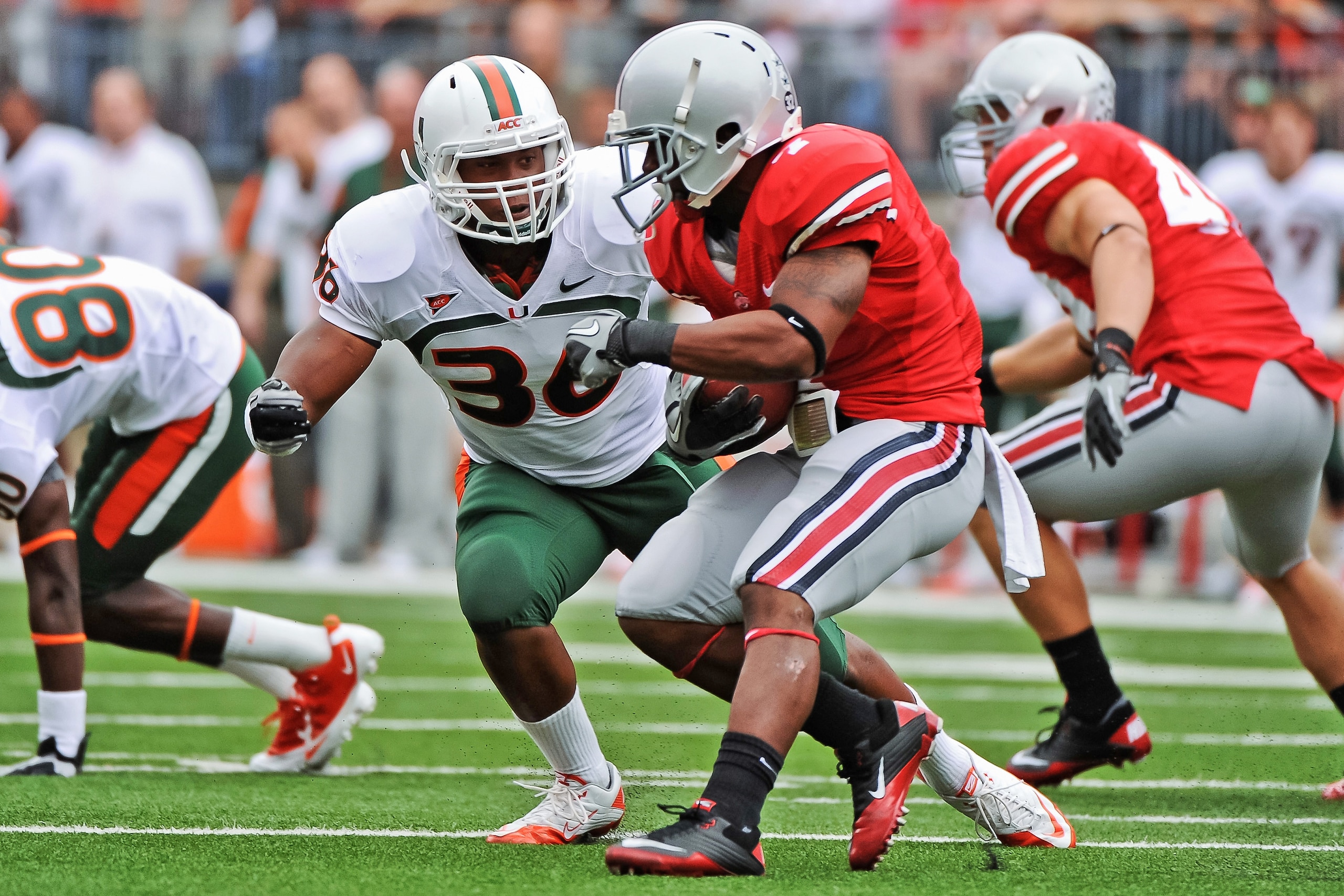 COLUMBUS, OH - SEPTEMBER 11:  Kylan Robinson #36 of the Miami Hurricanes tackles Jordan Hall #7 of the Ohio State Buckeyes  at Ohio Stadium on September 11, 2010 in Columbus, Ohio.  (Photo by Jamie Sabau/Getty Images)